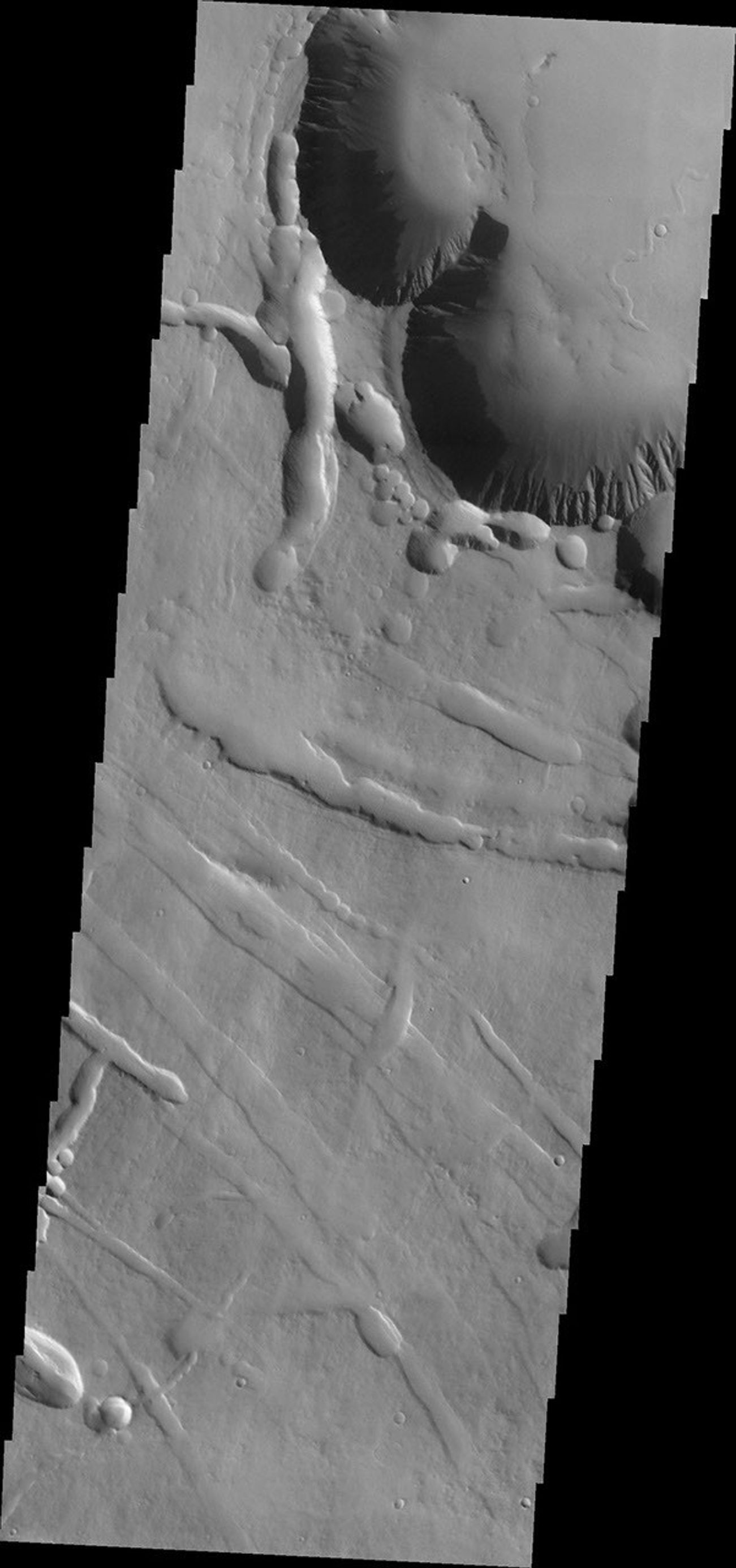 This image from NASA's Mars Odyssey spacecraft shows the beginning of Pavonis Chasma (top of frame) on the northern flank of Pavonis Mons.
