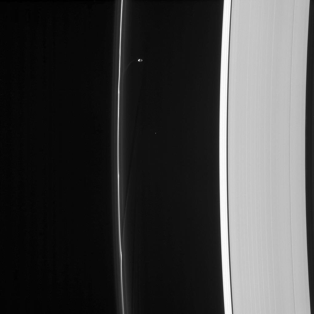 Saturn's moon Prometheus orbits near some of its handiwork in the F ring in this image from NASA's Cassini spacecraft. Prometheus and its partner Pandora gravitationally sculpt and maintain the narrow F ring.
