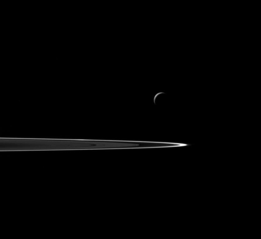 Following a successful close flyby of Enceladus, NASA's Cassini spacecraft captured this artful composition of the icy moon with Saturn's rings beyond.