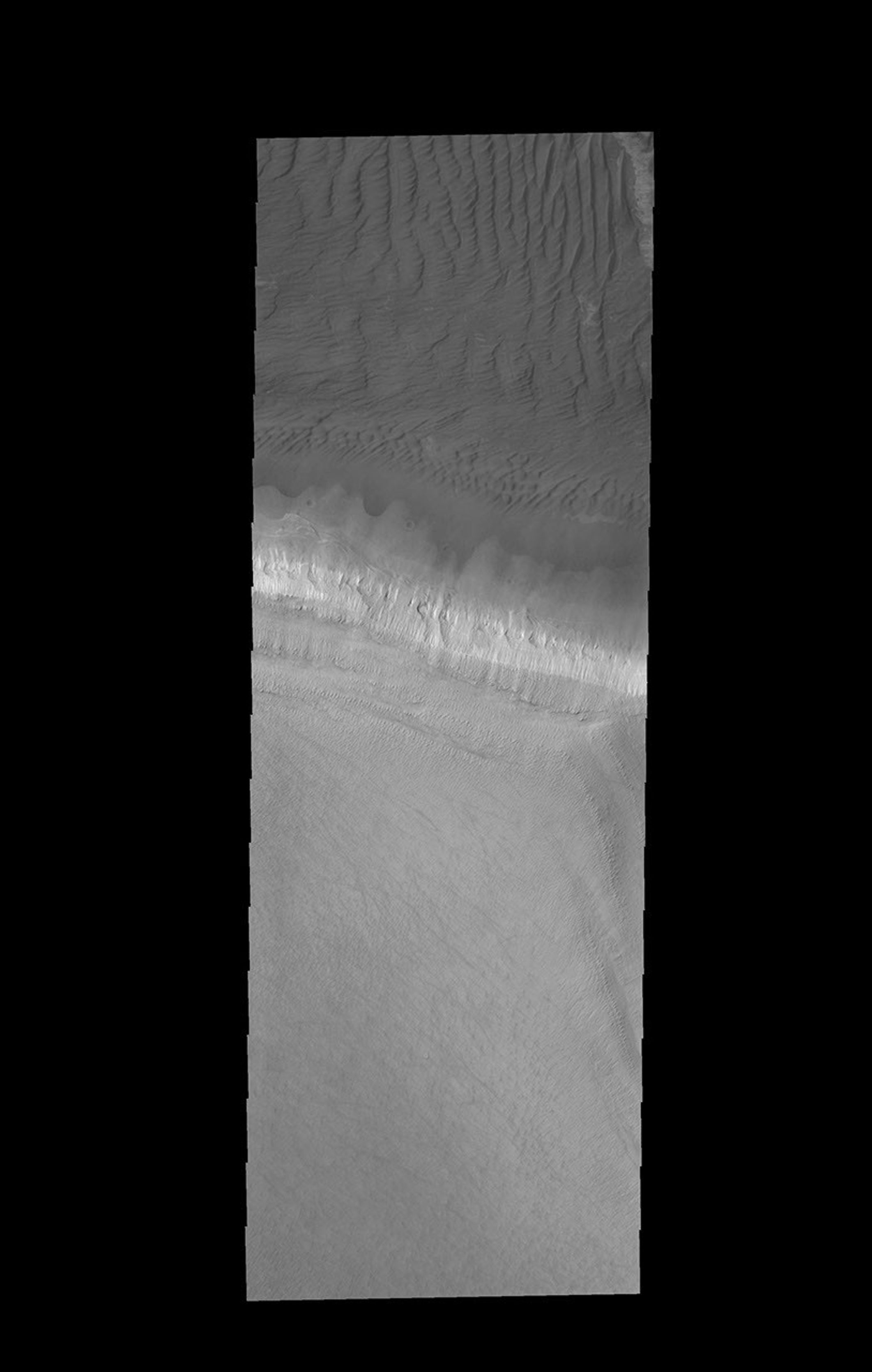 The edge of the south polar cap is the bright band in the center of this image captured by NASA's 2001 Mars Odyssey spacecraft.