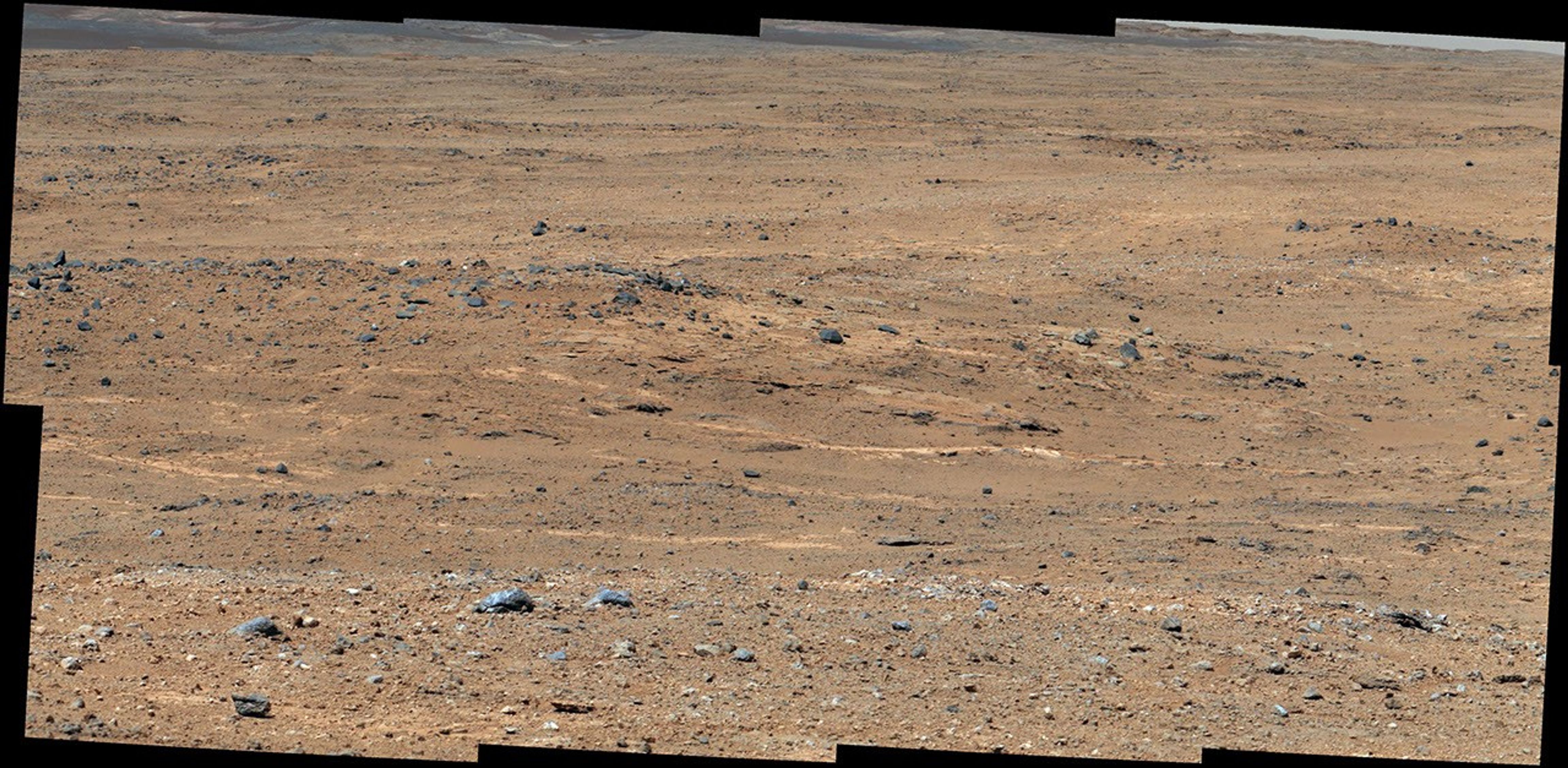 An outcrop visible as light-toned streaks in the lower center of this image has been chosen as a place for NASA's Mars rover Curiosity to study for a few days in September 2013.