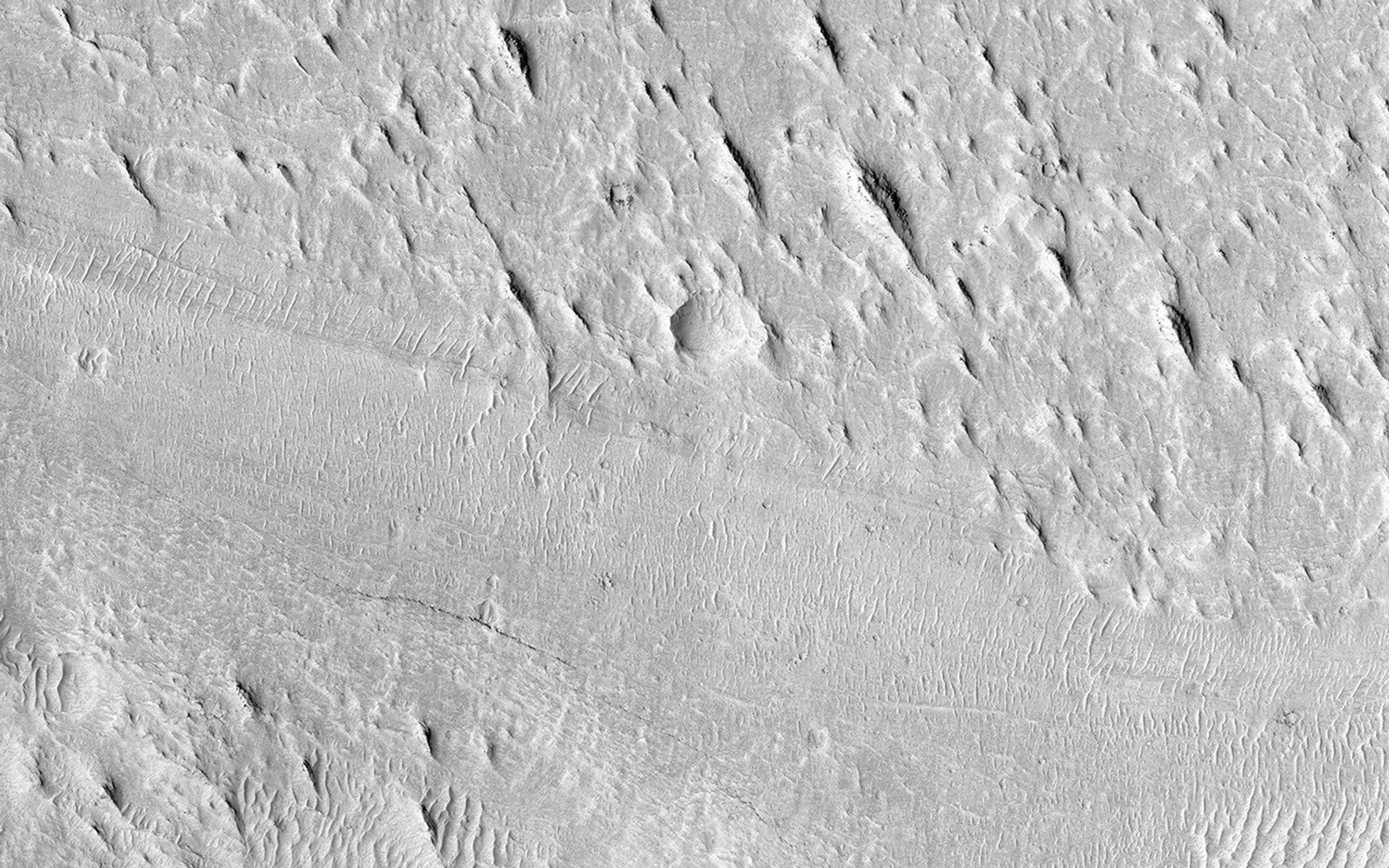 Shown here is an exceptionally long sinuous ridge, possibly an inverted fluvial feature, that cuts across newly mapped geologic units of the Medusae Fossae Formation, from NASA's Mars Reconnaissance Orbiter.