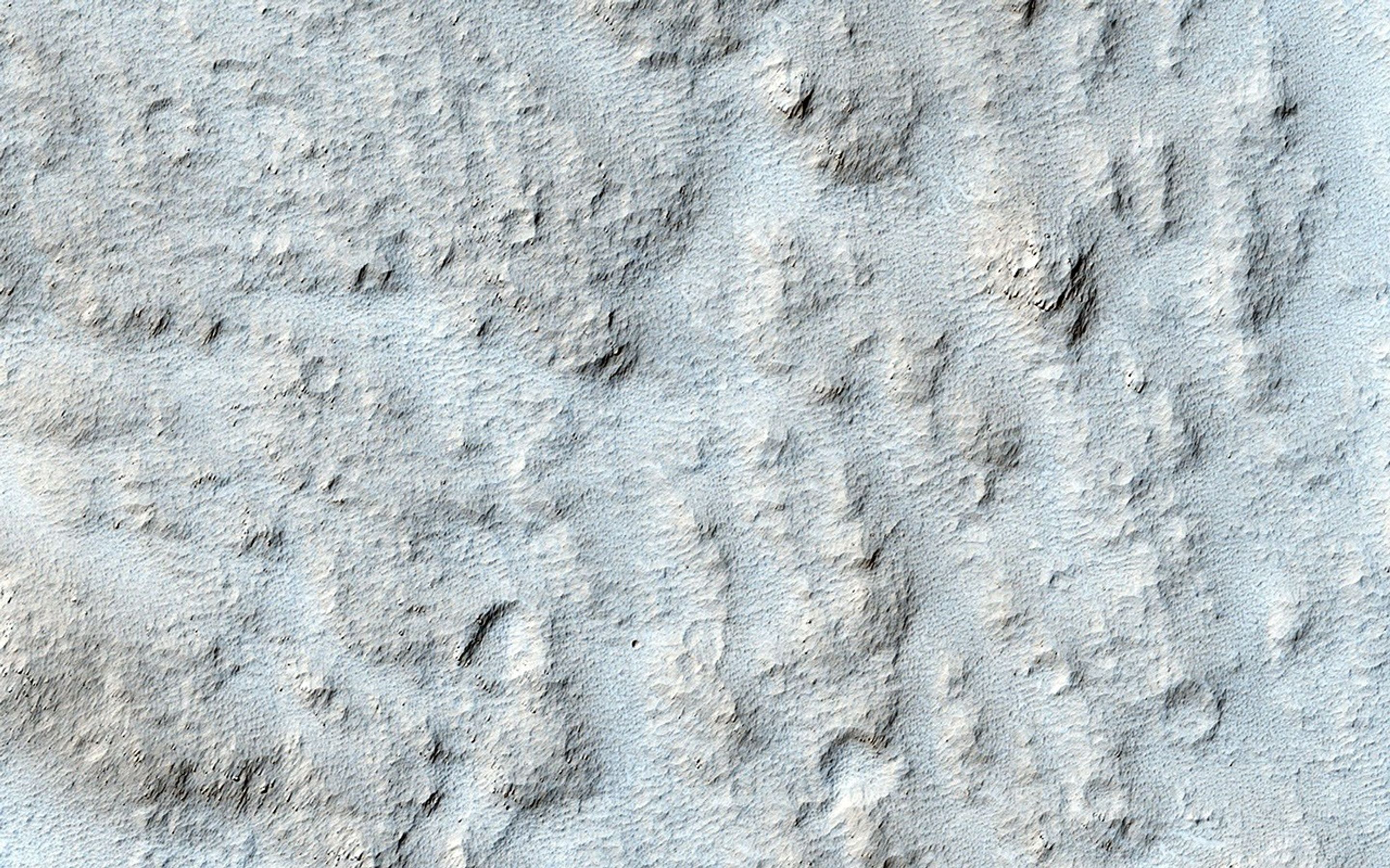 This particular area, called Mangala Valles and located near the Tharsis region, may be an example of the action of liquid water in the ancient Martian past. This image is from NASA's Mars Reconnaissance Orbiter.
