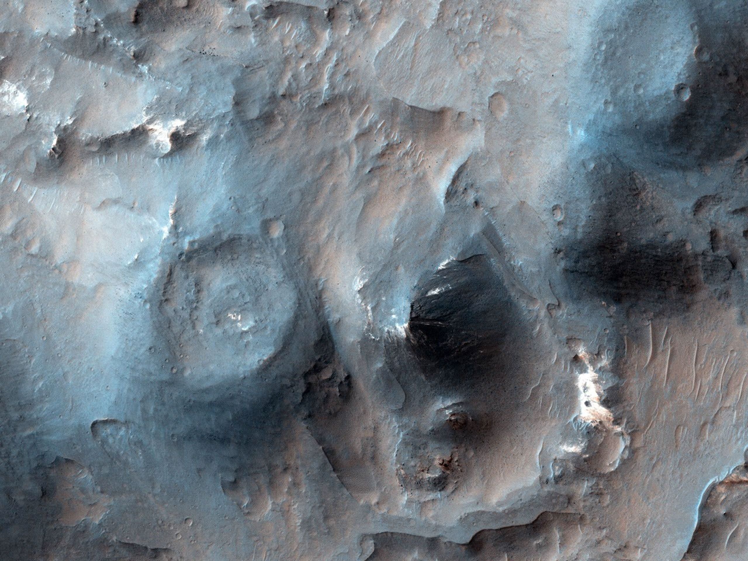This image from NASA's Mars Reconnaissance Orbiter shows cones with summit pits that are very similar to cinder cones on Earth. They are also very well-preserved, peppered by only small impact craters, so they must be geologically young.