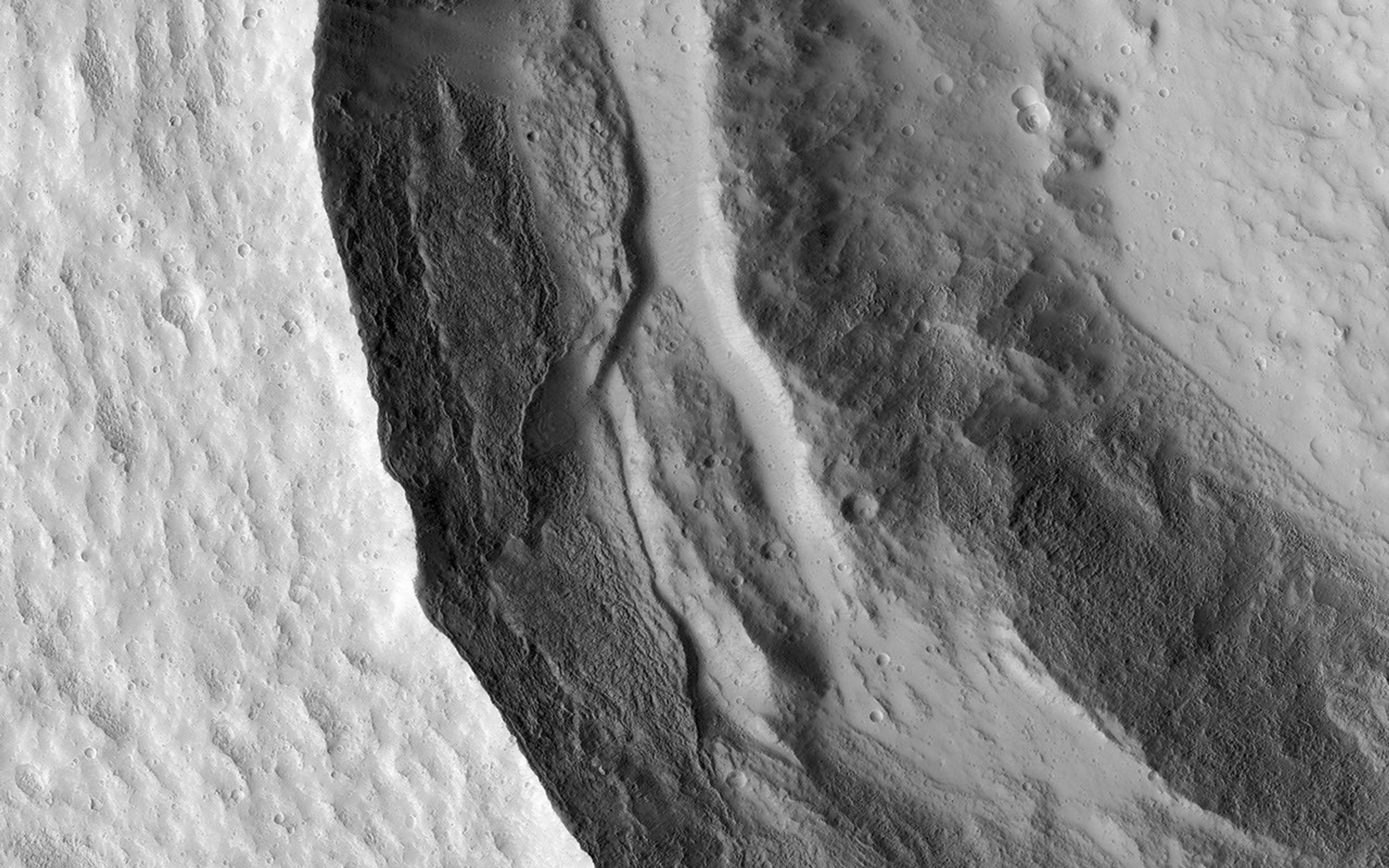 This image from NASA's Mars Reconnaissance Orbiter shows the western rim of a well-preserved 8.5-kilometer (about 5 miles) diameter impact crater.