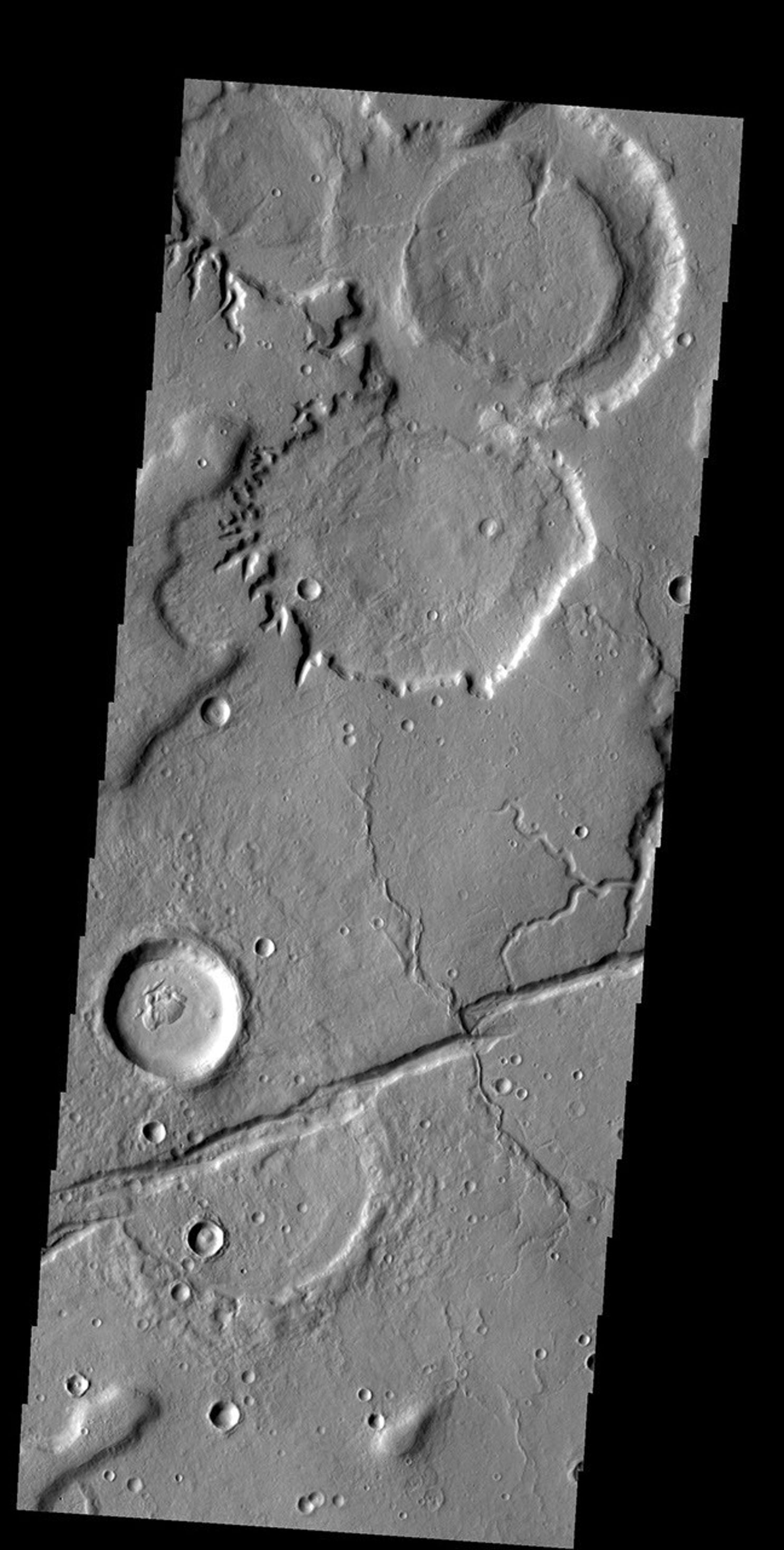 The crater gullies, channels and fractures in this image taken by NASA's 2001 Mars Odyssey spacecraft are located on the eastern margin of Tempe Terra.