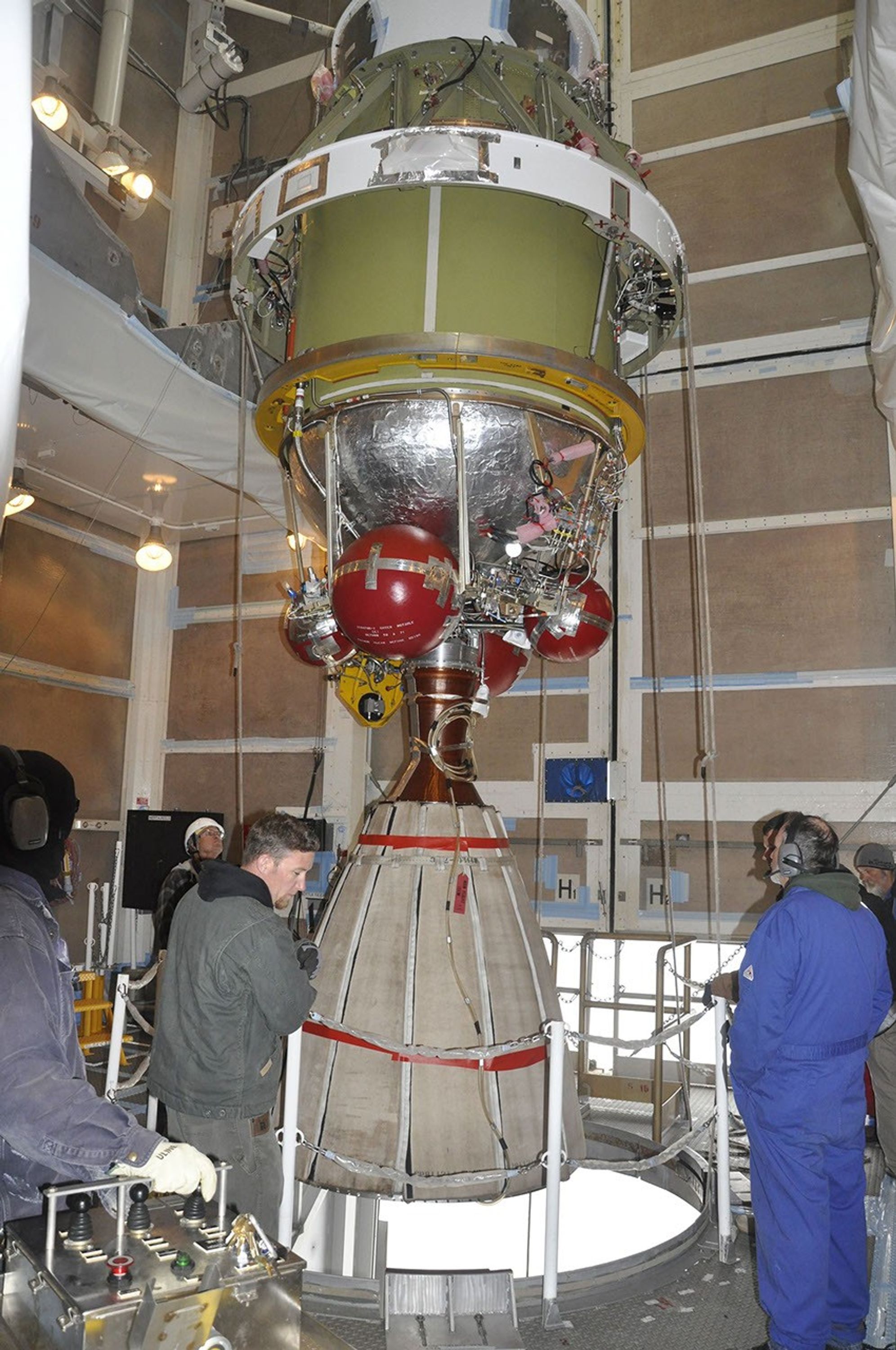 Workers monitor the Delta II second stage for NASA's OCO-2, as it is lifted into position for mating with the rocket's first stage in the mobile service tower at Space Launch Complex 2 on Vandenberg Air Force Base in California.