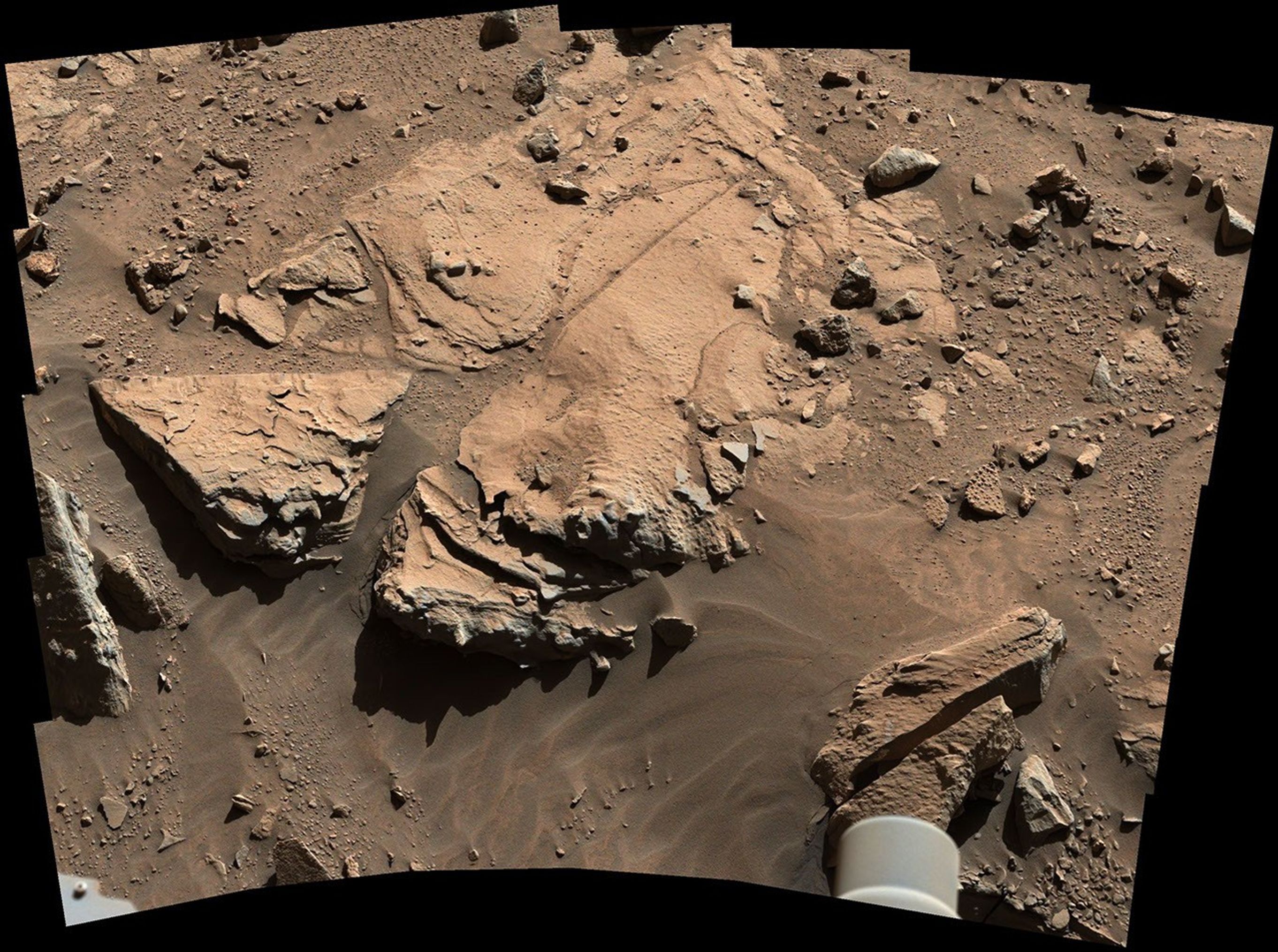 NASA's Curiosity Mars rover has driven within robotic-arm's reach of the sandstone slab at the center of this view.