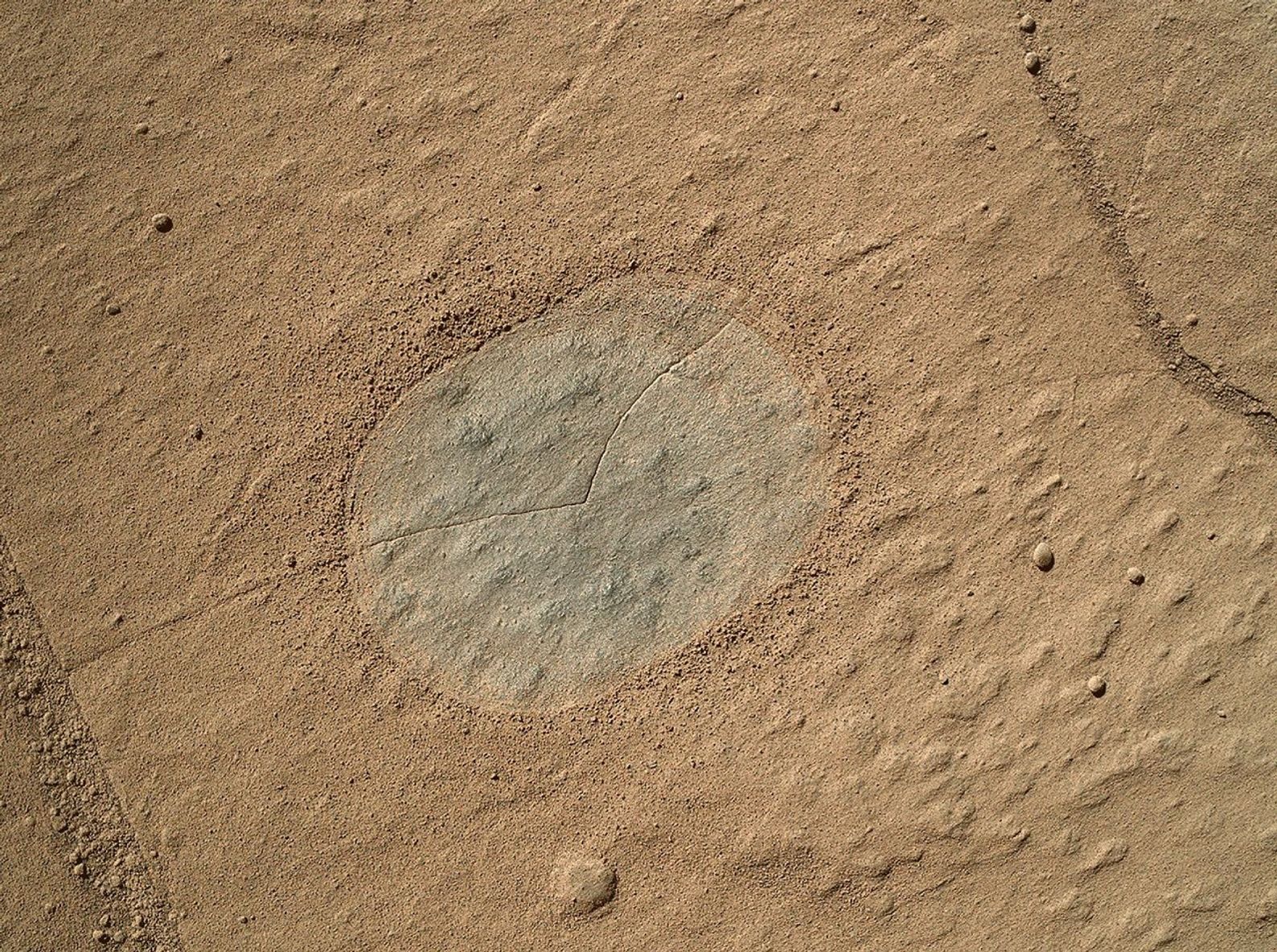 This image from an animation shows a patch of sandstone scrubbed with the Dust Removal Tool, a wire-bristle brush, on NASA's Curiosity Mars rover. This rock target is called 'Windjana,' after a gorge in Western Australia.