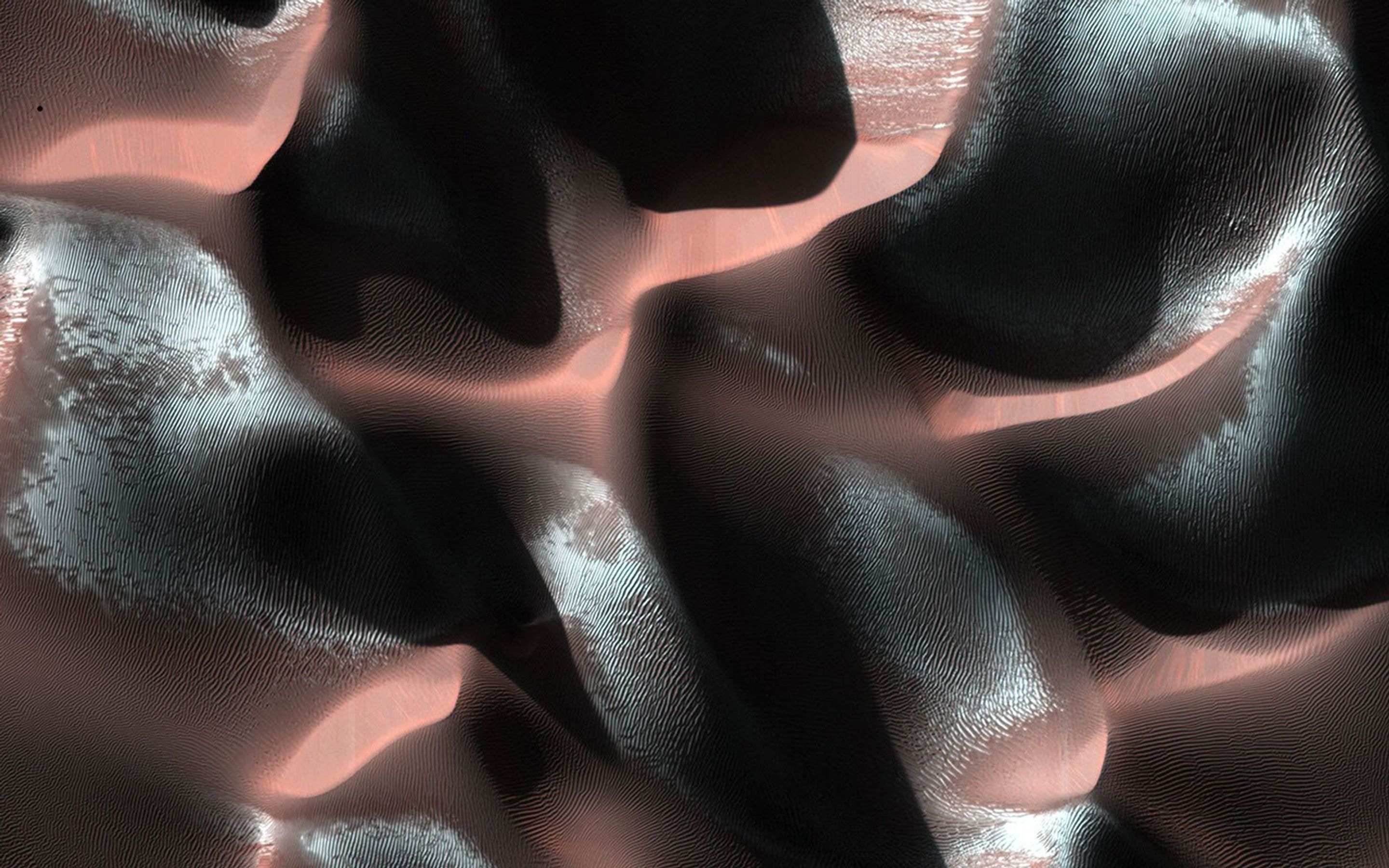 Especially bright patches, bluish in enhanced color, are due to seasonal frost that is accumulating as this hemisphere approaches winter. This image of a sand dune field in a Southern highlands crater was acquired by NASA's Mars Reconnaissance Orbiter.