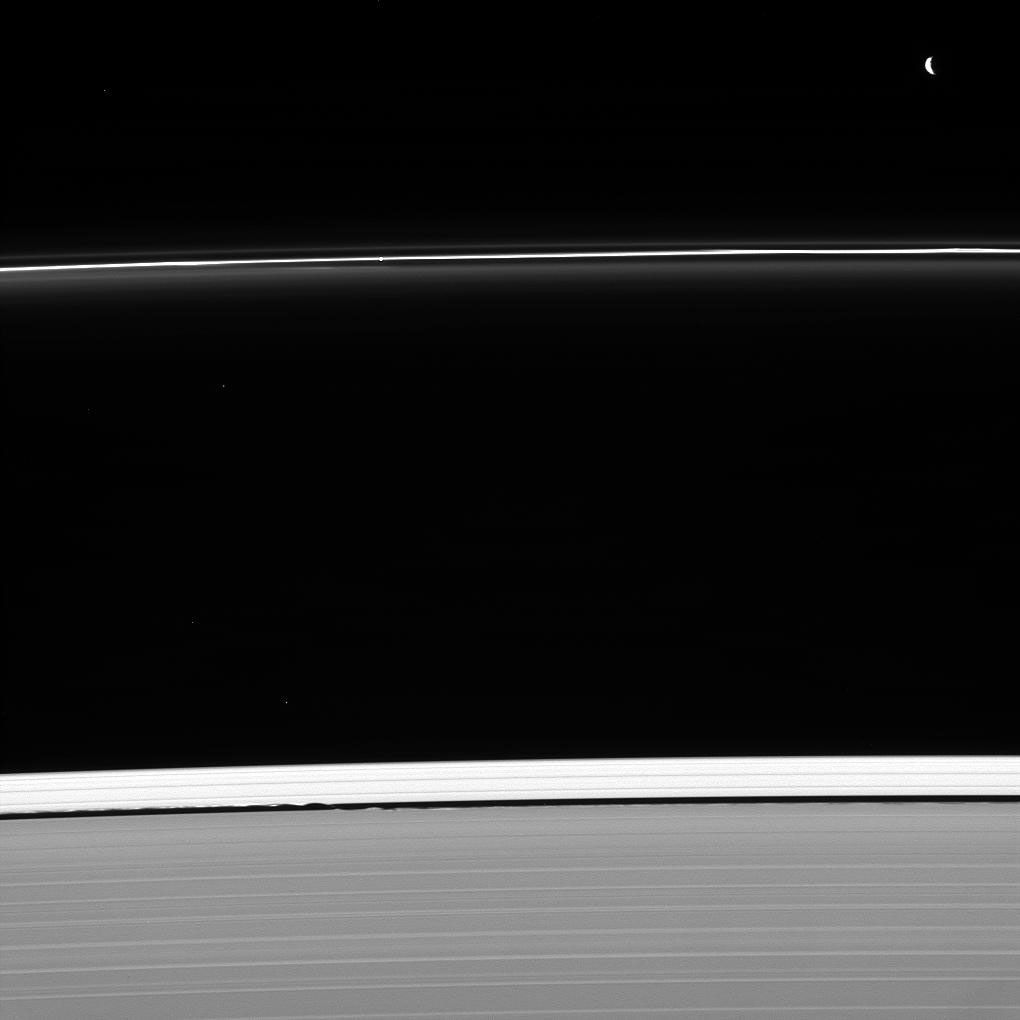 Two masters of their craft are caught at work shaping Saturn's rings captured by NASA's Cassini spacecraft. Pandora (upper right) sculpts the F ring. Meanwhile, Daphnis is busy holding open the Keeler gap (bottom center).