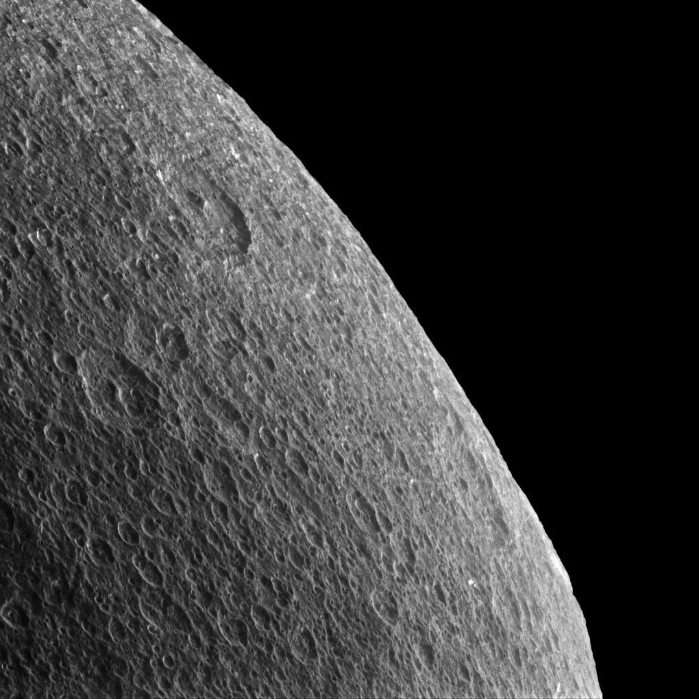 Rhea's horizon is slightly irregular and battered by craters, so thoughts inevitably turn towards the forces that shape these icy worlds. This image is from NASA's Cassini spacecraft.