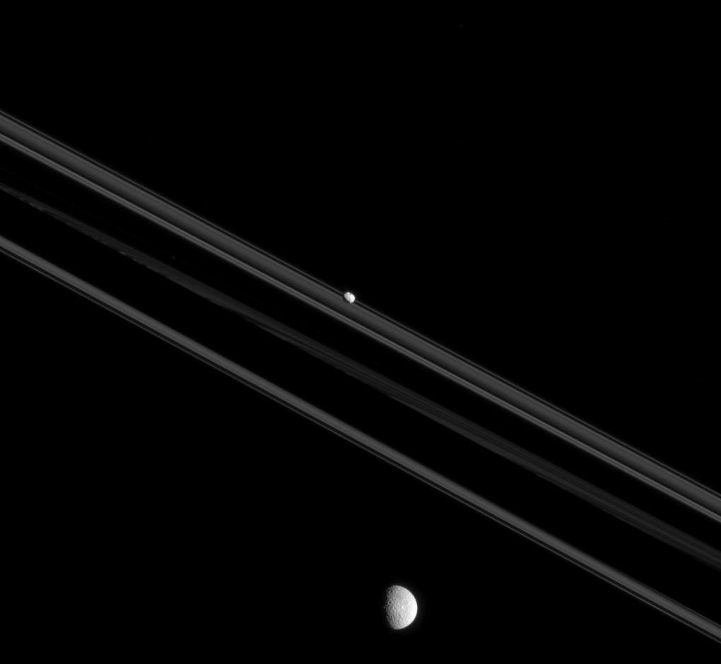 Although Mimas and Pandora, shown here, both orbit Saturn, they are very different moons. The shapes of moons can teach us much about their history. This image is from NASA's Cassini spacecraft.