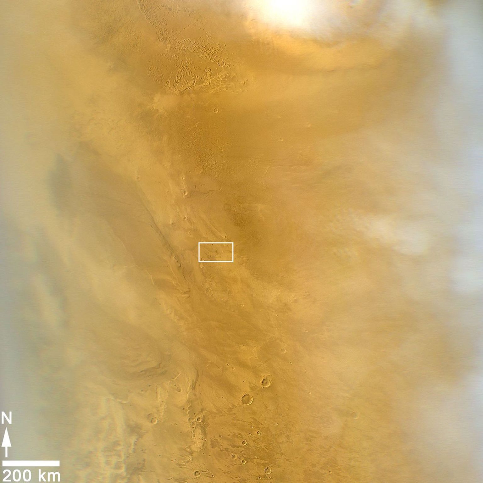This March 20, 2014, image from the MARCI camera on NASA's Mars Reconnaissance Orbiter has a dark spot (at center of rectangle) noticed while the image was being examined for a weather report.