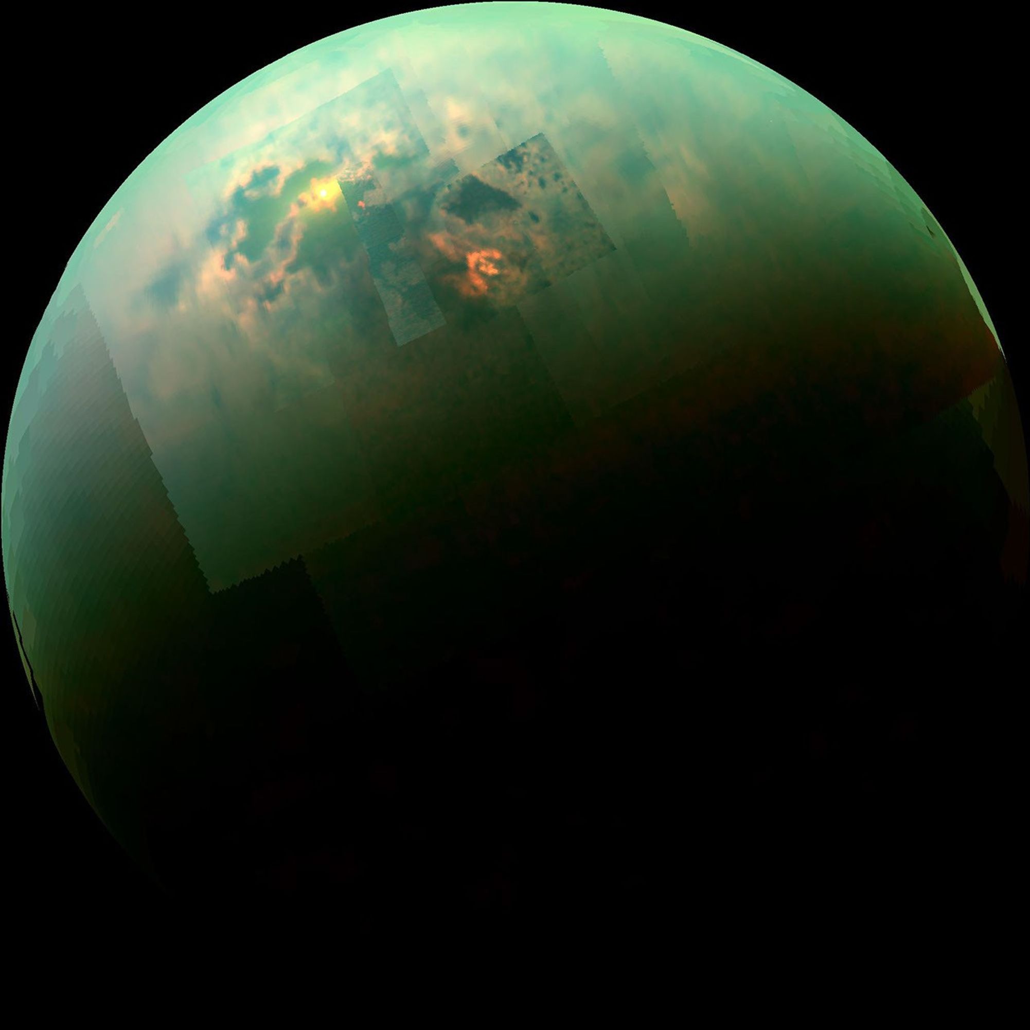 This near-infrared, color view from NASA'S Cassini orbiter shows the sun glinting off of Titan's north polar seas.