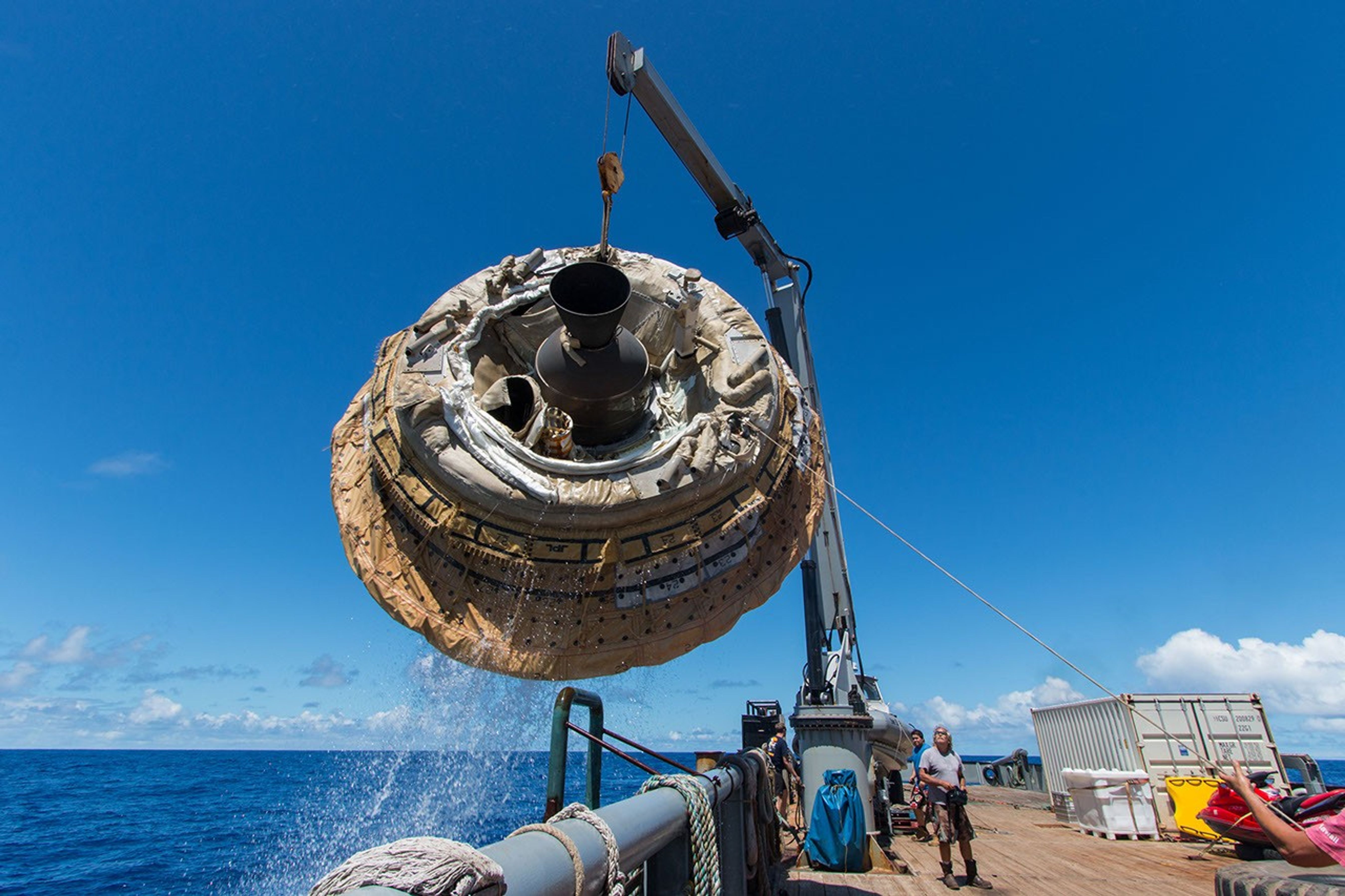 Hours after the June 28, 2014, test of NASA's Low-Density Supersonic Decelerator over the U.S. Navy's Pacific Missile Range, the saucer-shaped test vehicle is lifted aboard the Kahana recovery vessel.