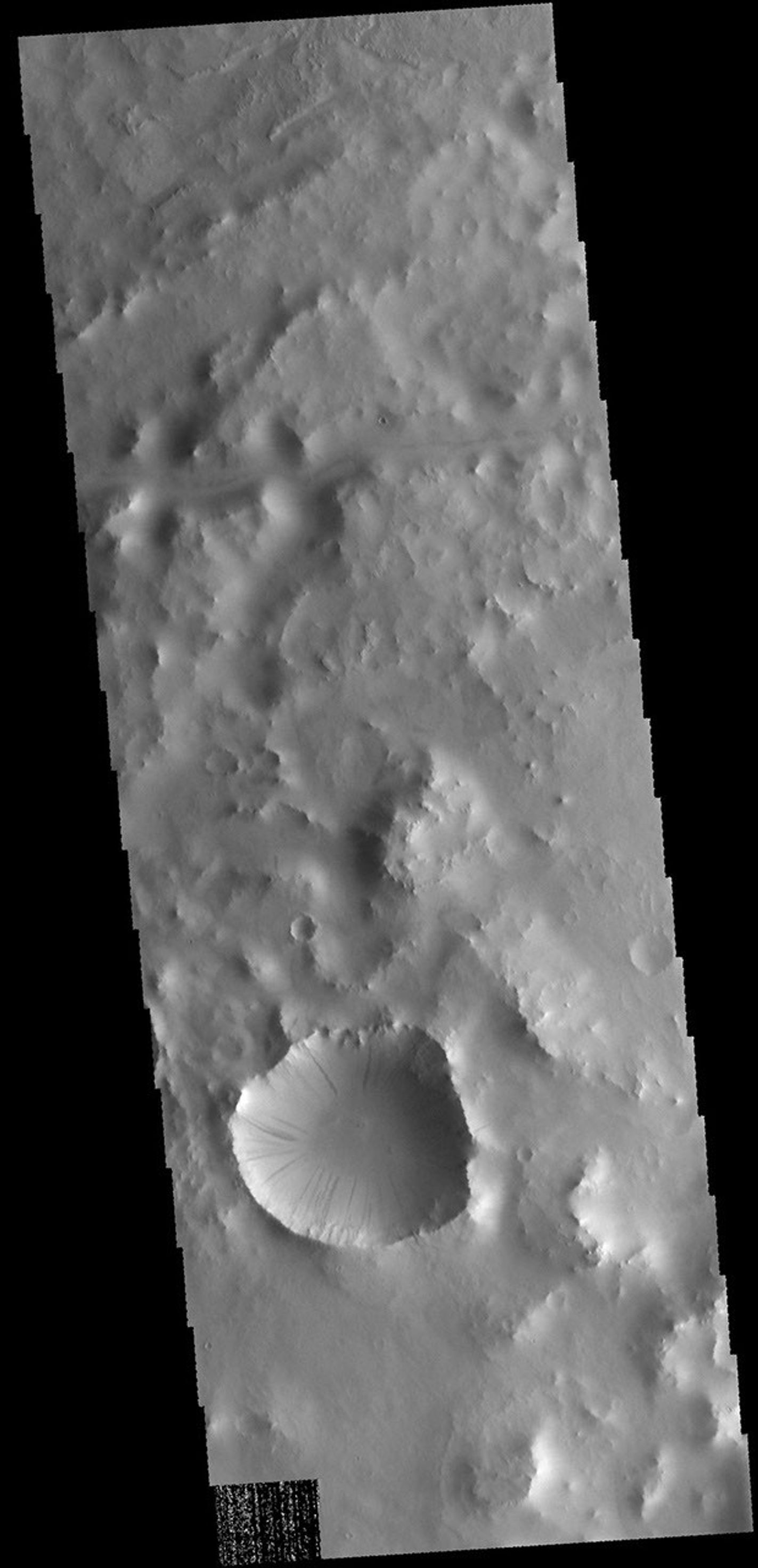 This image from NASA's 2001 Mars Odyssey spacecraft shows dark slope streaks in an unnamed crater in Terra Sabaea. These features are believed to be formed by material moving downslope, removing the dust cover and revealing darker material.