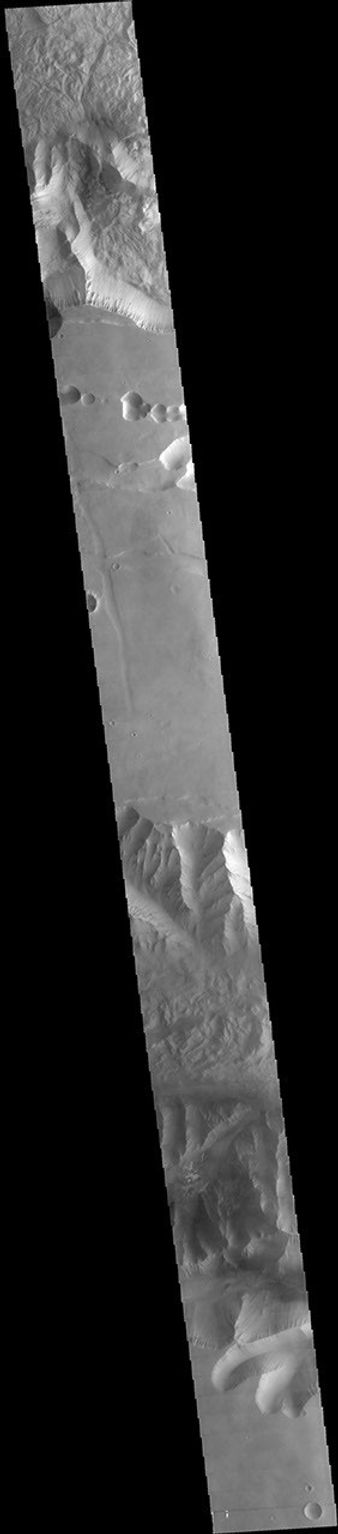 This image captured by NASA's 2001 Mars Odyssey spacecraft spans from Tithonium Chasma (top of image) to Ius Chasma (bottom of image).