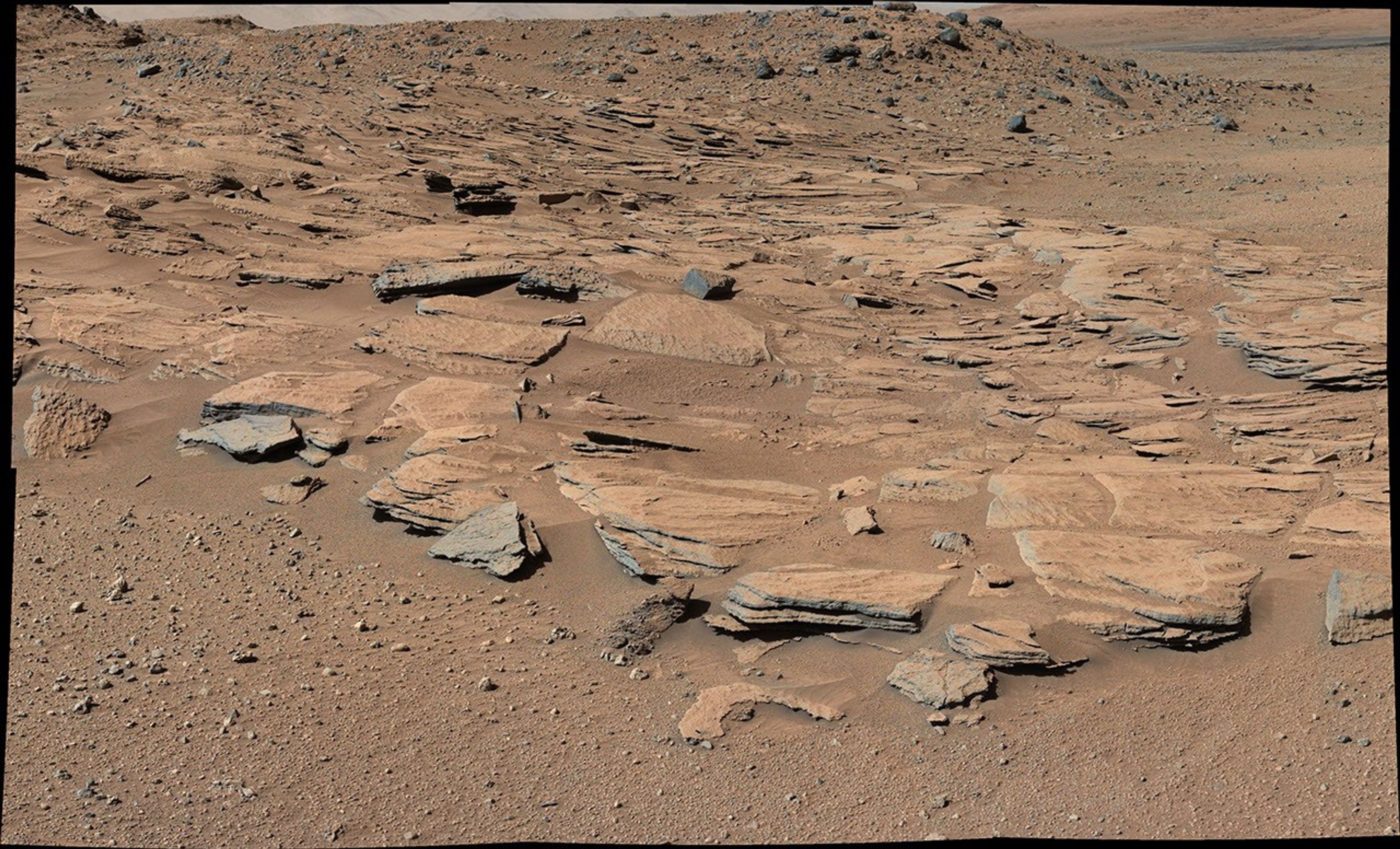 This image from Curiosity's Mastcam shows inclined beds of sandstone interpreted as the deposits of small deltas fed by rivers flowing down from the Gale Crater rim and building out into a lake where Mount Sharp is now.