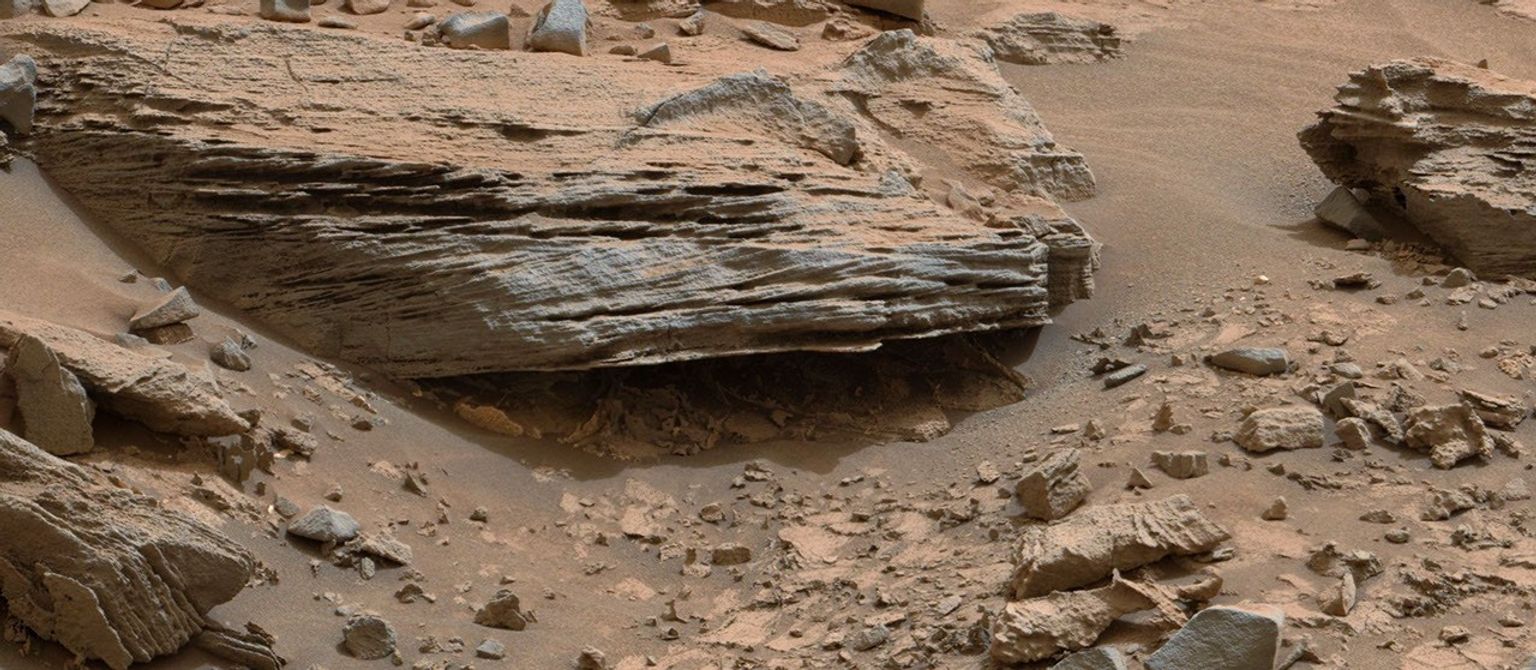 Cross-bedding seen in the layers of this Martian rock is evidence of movement of water recorded by the waves or ripples of loose sediment the water passed over, such as a current in a lake. This image is from NASA's Curiosity Mars rover.