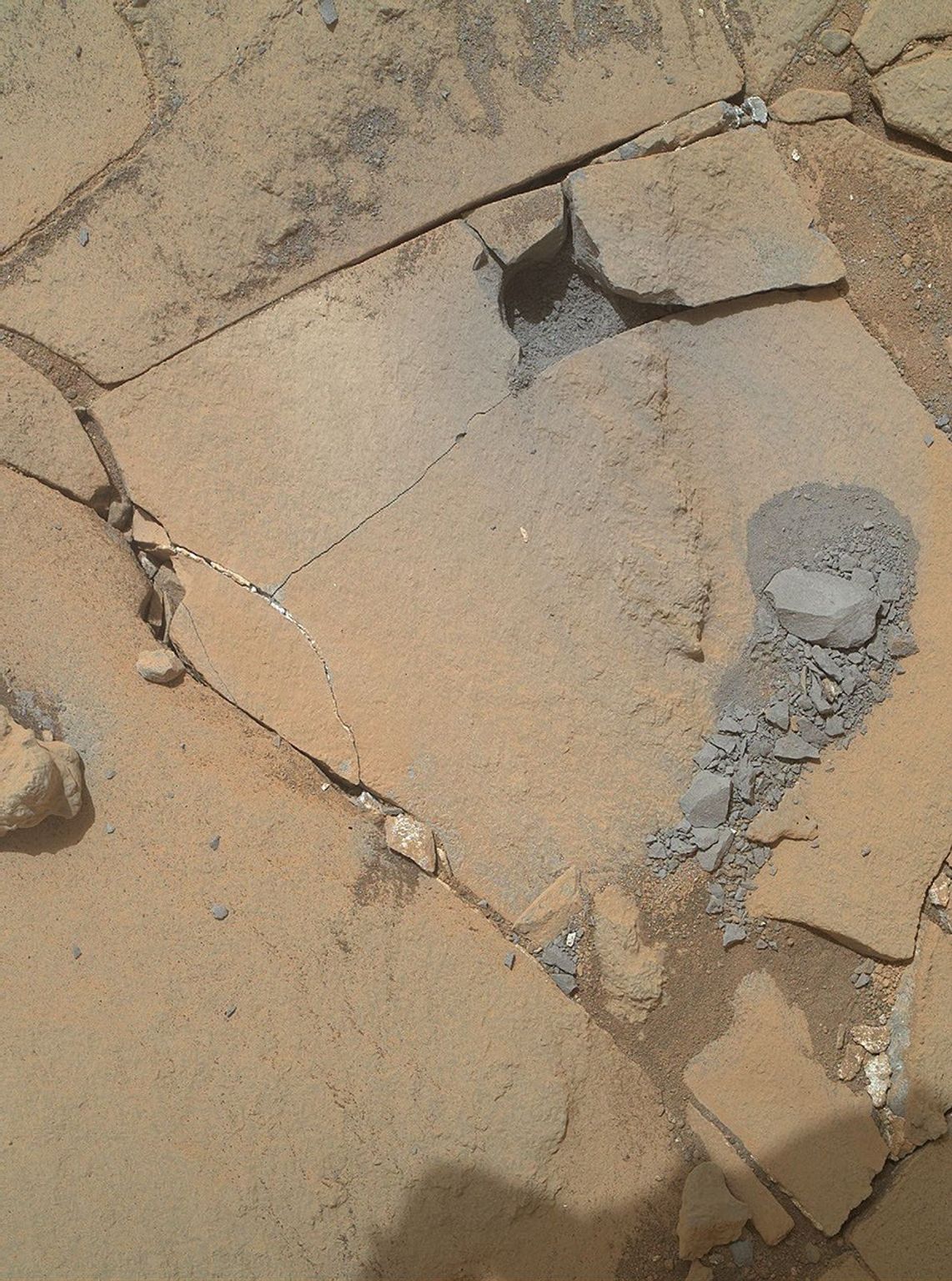 This Jan. 13, 2015, view from NASA's Curiosity Mars rover shows outcomes of a mini-drill test to assess whether the 'Mojave' rock is appropriate for full-depth drilling to collect a sample.