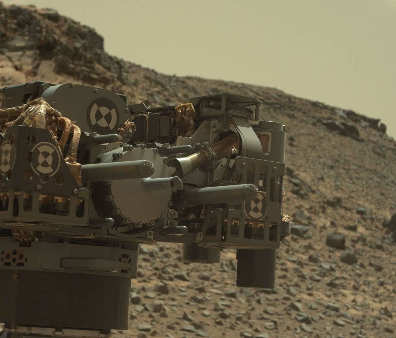 This raw-color view from Curiosity's Mastcam shows the rover's drill just after finishing a drilling operation at 'Telegraph Peak' on Feb. 24, 2015.