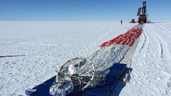 Prior to launch, the team laid out the parachute and hang lines in front of SPIDER, seen in the distance. The long-duration balloon that would carry SPIDER into the sky is attached to the end of the parachute shown here in the foreground.