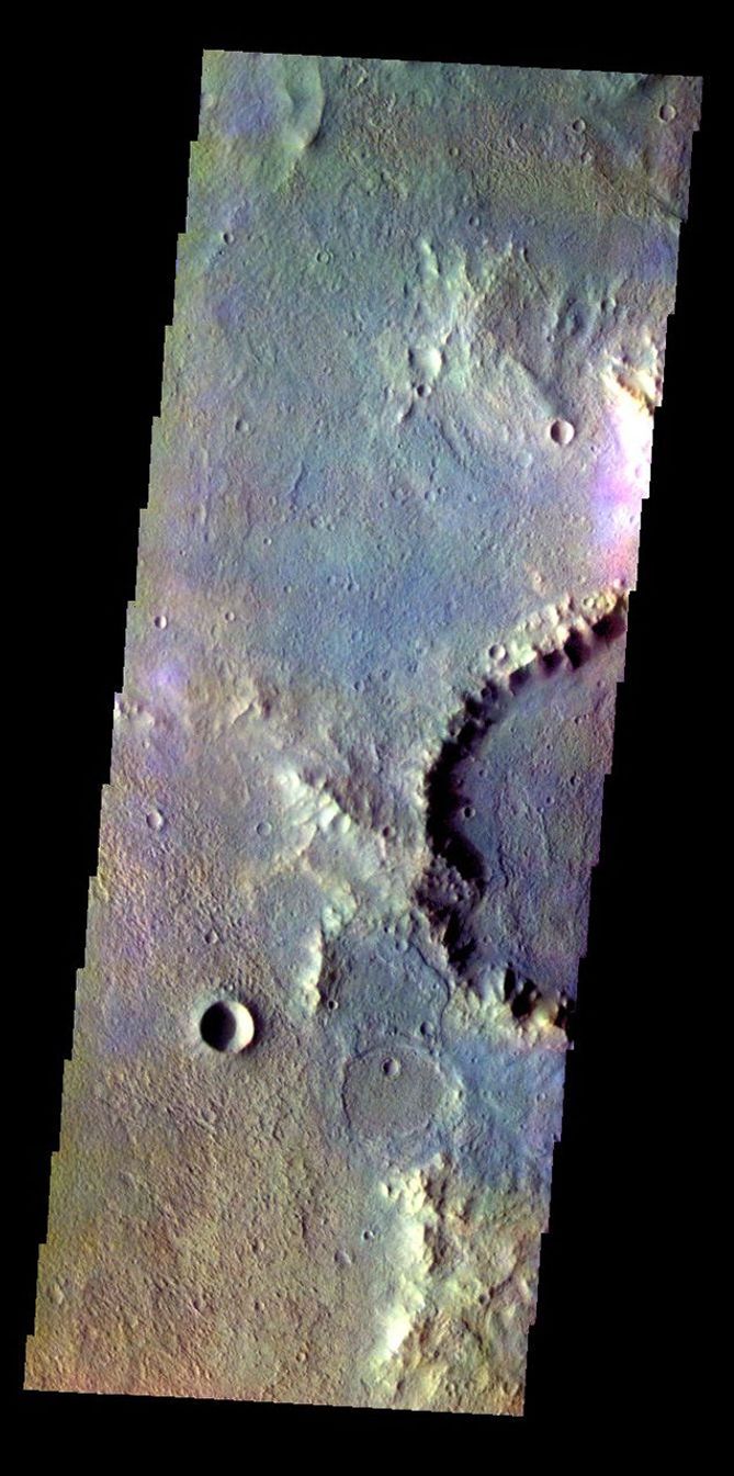 The THEMIS VIS camera contains 5 filters. The data from different filters can be combined in multiple ways to create a false color image. This false color image from NASA's 2001 Mars Odyssey spacecraft shows part of the floor of Muller Crater.