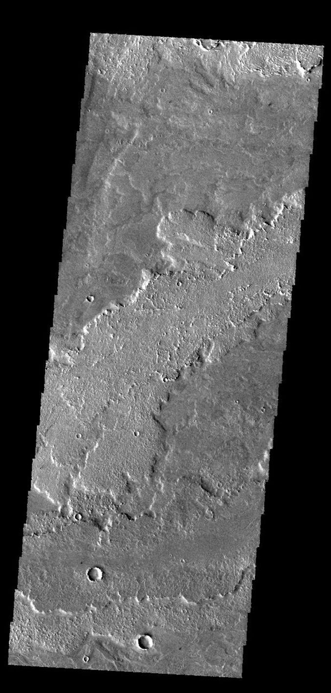 This image from NASA's 2001 Mars Odyssey spacecraft shows a small portion of the lava flows that make up Daedalia Planum. These flows originate at Arsia Mons.