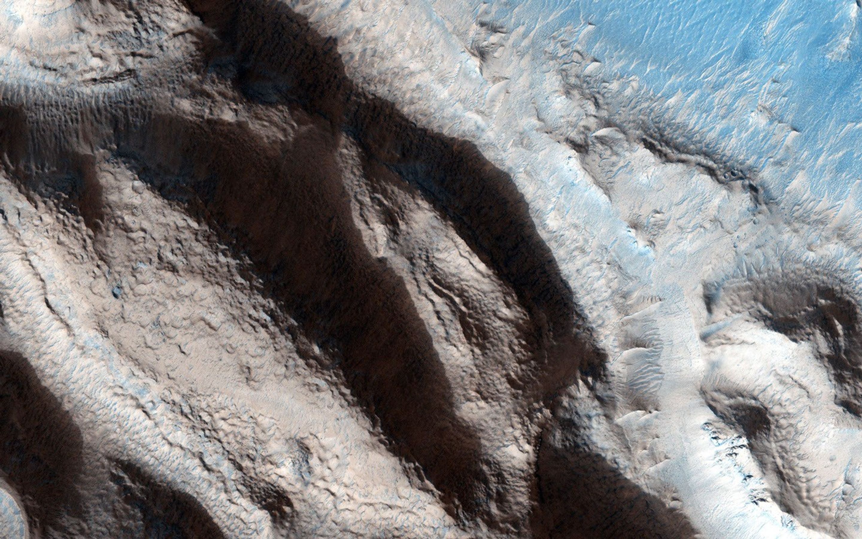 This relatively fresh, shallowly incised valley was once filled with water and/or ice and flowed to the west toward a large, local depression in northern Arabia Terra as seen by NASA's Mars Reconnaissance Orbiter.