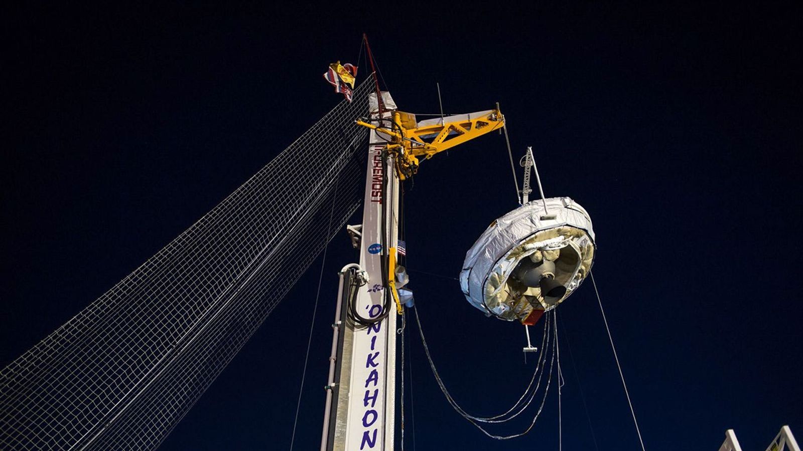 NASA's Low-Density Supersonic Decelerator hangs from a launch tower at U.S. Navy's Pacific Missile Range Facility in Kauai, Hawaii. The saucer-shaped vehicle will test two devices for landing heavy payloads on Mars.
