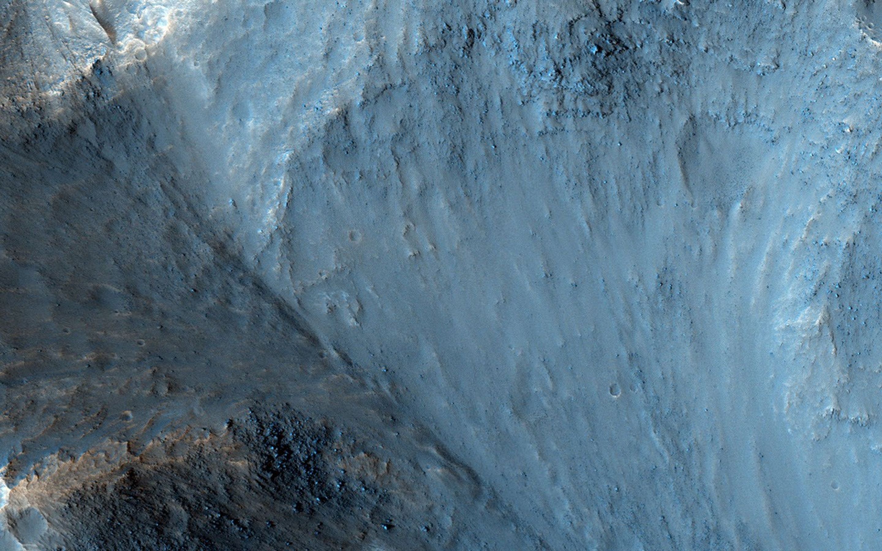 Osuga Valles lies around 170 kilometers to the south of Eos Chasma, which is at the eastern end of the vast Valles Marineris canyon system as seen by NASA's Mars Reconnaissance Orbiter.
