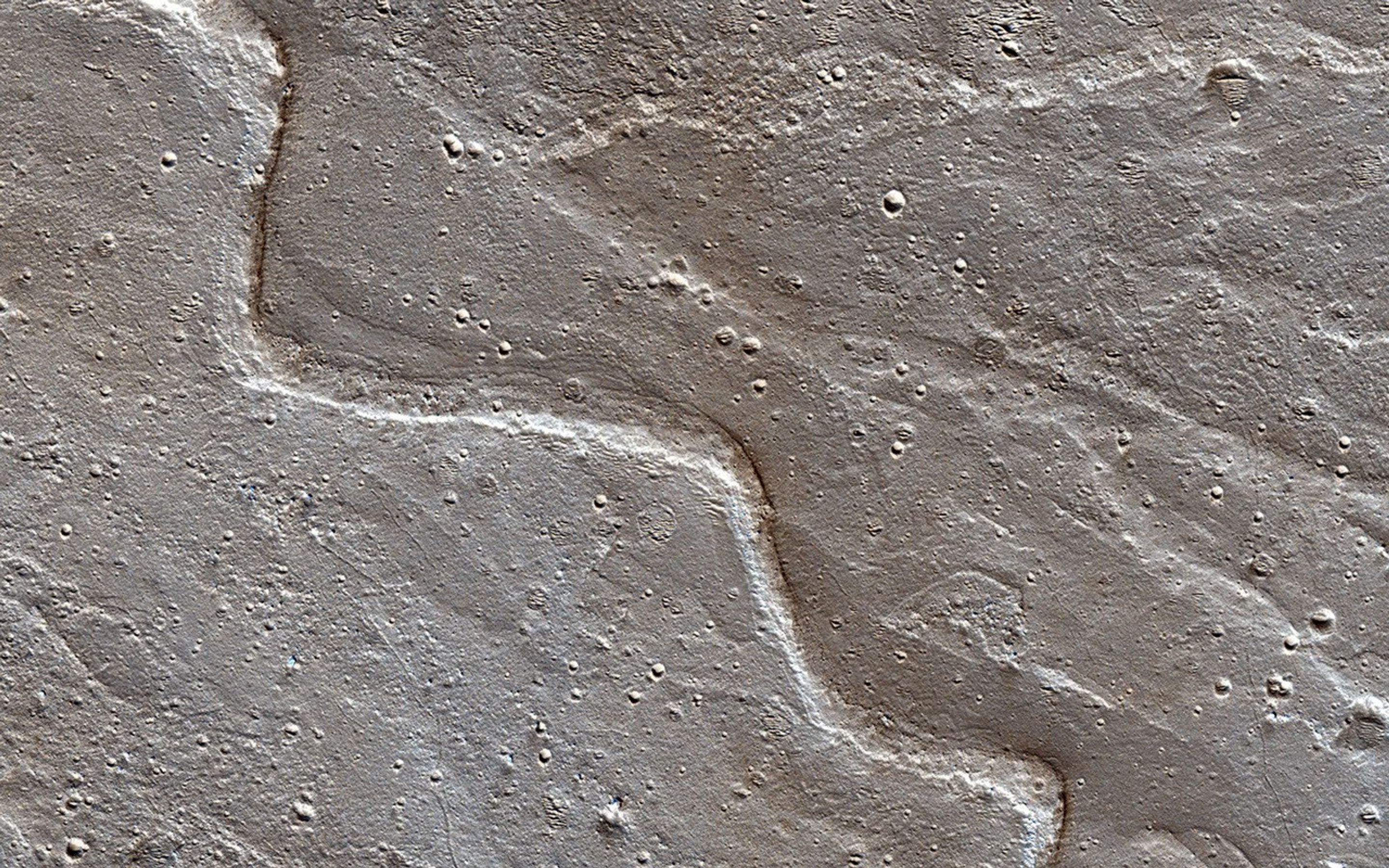 Alluvial fans are piles of debris dumped by rivers when they emerge from the mountains and enter a mostly dry valley as seen by NASA's Mars Reconnaissance Orbiter.