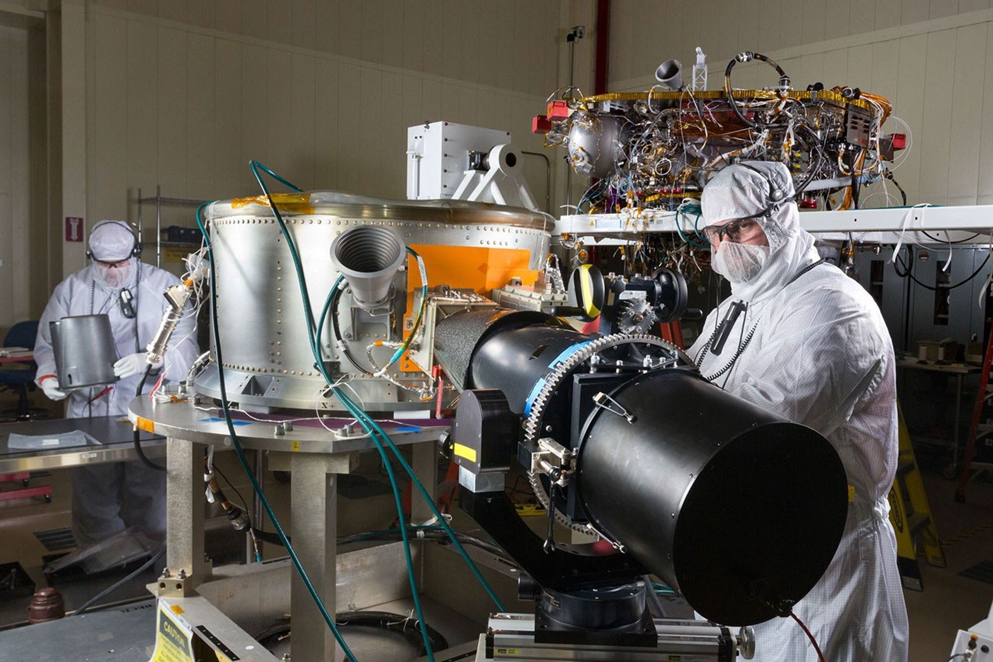 Spacecraft specialists in a clean room at Lockheed Martin Space Systems, Denver, are working on NASA's InSight spacecraft in this January 2015 scene from the mission's assembly and testing phase.