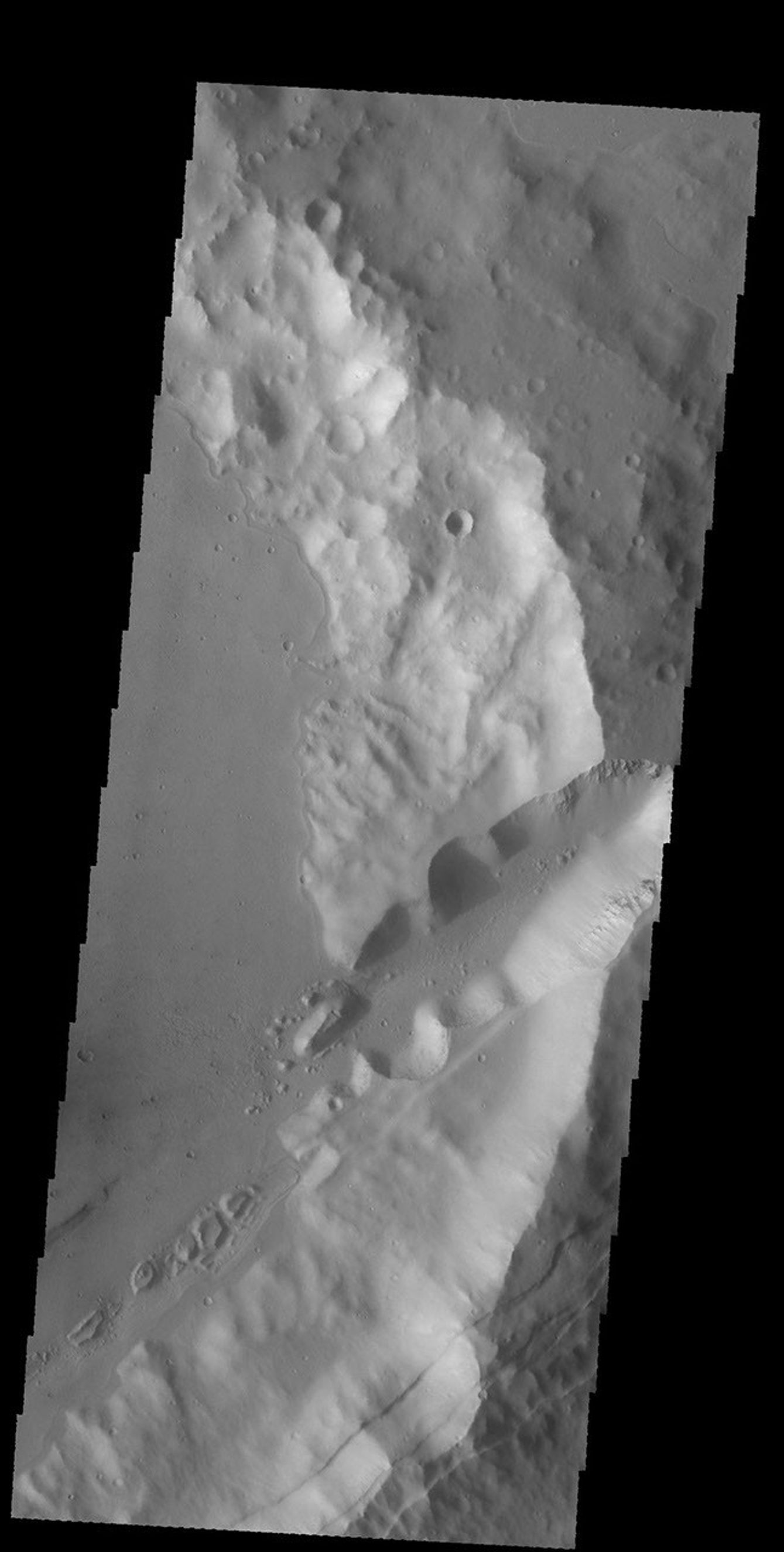 The linear features in this image from NASA's 2001 Mars Odyssey spacecraft are faults. Where depressions are formed bounded by faulting the feature is called a graben. These faults and graben are part of a large region of faulting called Sirenum Fossae.