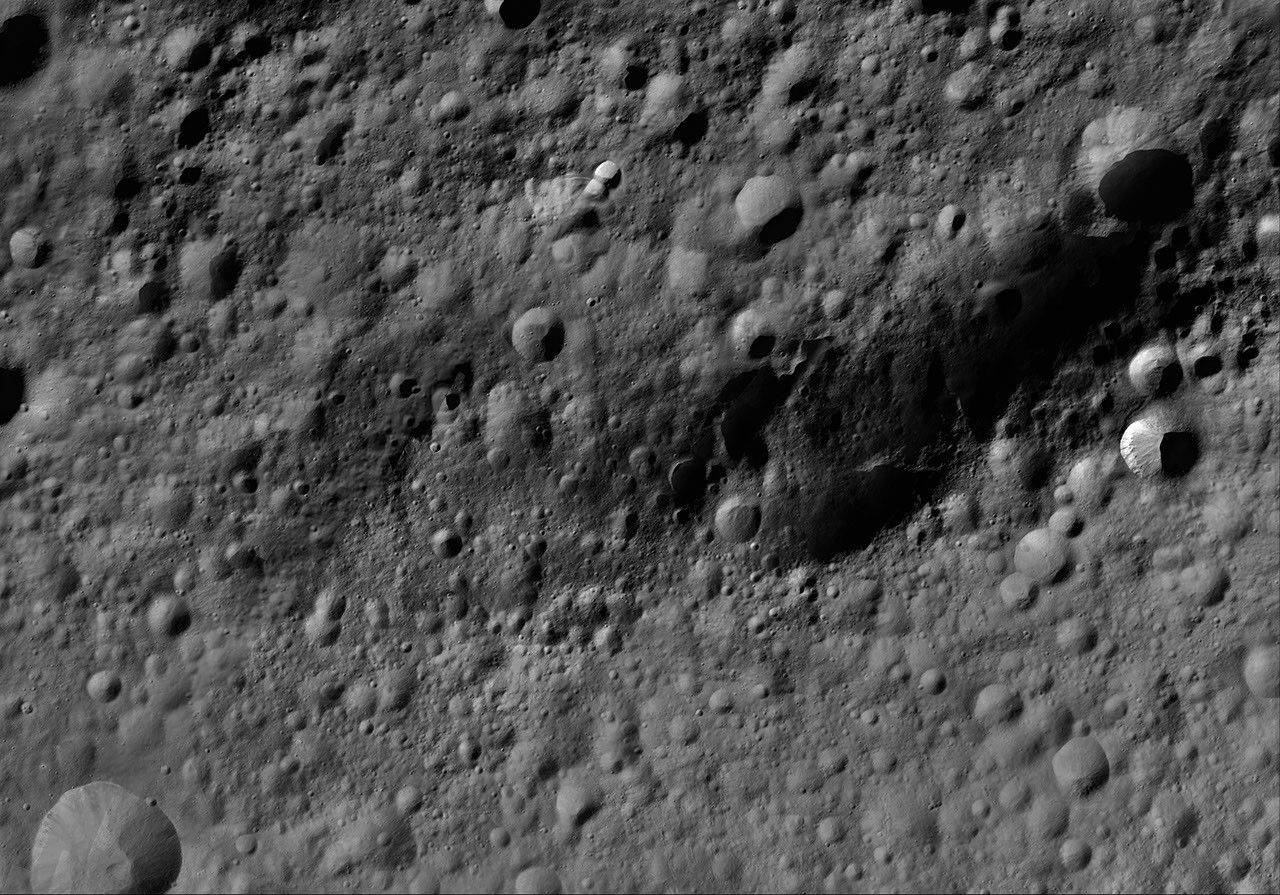 This image of Fabia AV-L-13, from the atlas of the giant asteroid Vesta, was created from images taken as NASA's Dawn mission flew around the object, also known as a protoplanet.