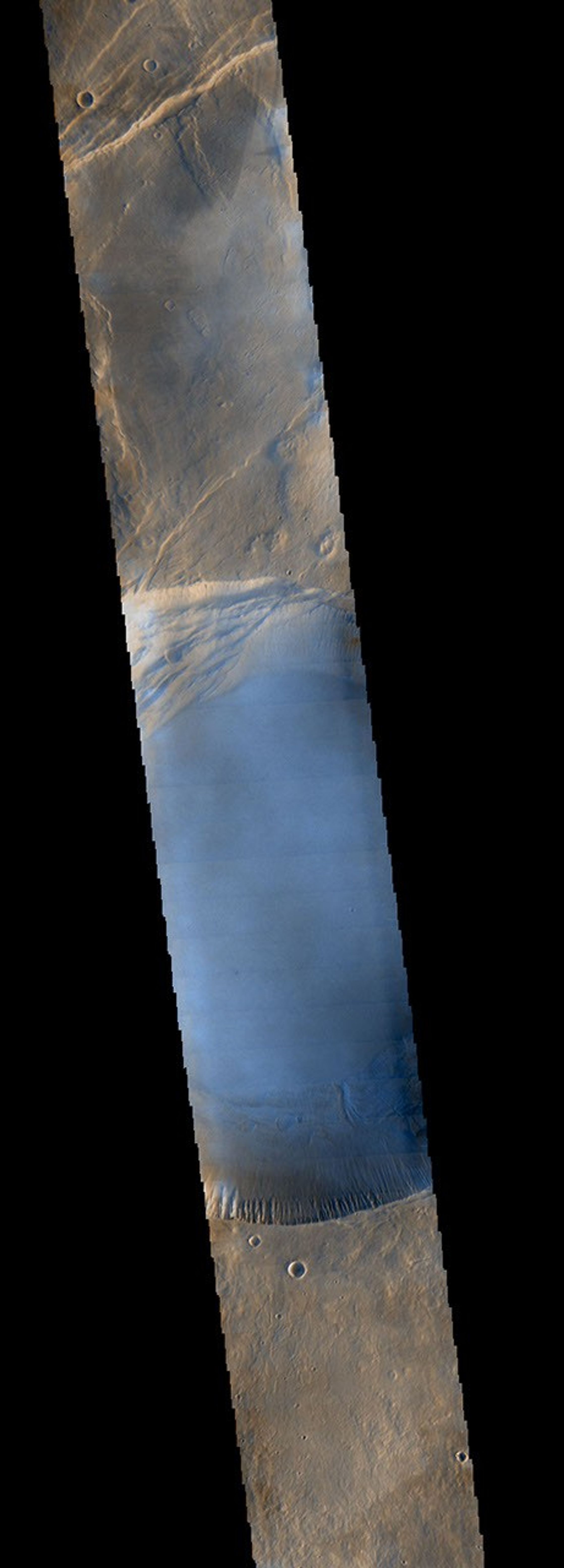 Seen shortly after local Martian sunrise, clouds gather in the summit pit, or caldera, of Pavonis Mons, a giant volcano on Mars, in this image from the Thermal Emission Imaging System (THEMIS) on NASA's Mars Odyssey orbiter.