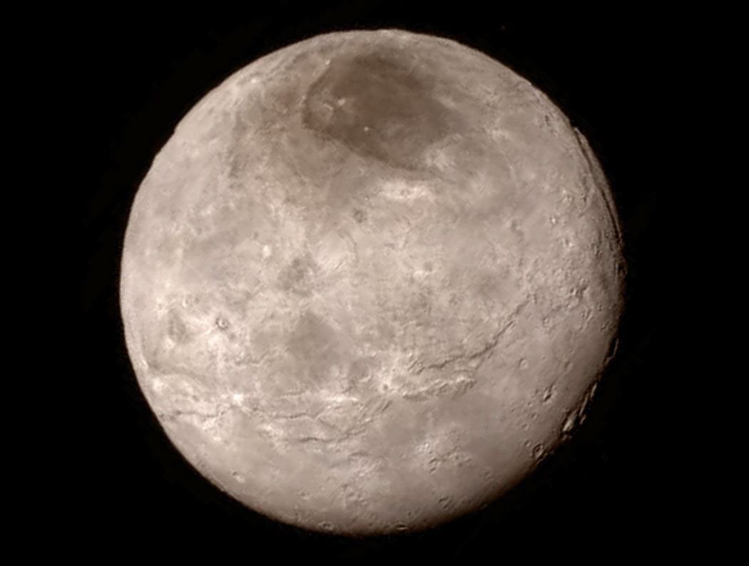 A swath of cliffs and troughs stretches about 600 miles (1,000 kilometers) on Pluto's largest moon Charon are revealed in this image from NASA'as New Horizon's spacecraft, taken late on July 13, 2015.