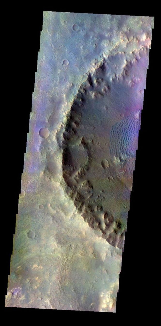 The THEMIS VIS camera contains 5 filters. Data from different filters can be combined in multiple ways to create a false color image. This image from NASA's 2001 Mars Odyssey spacecraft shows an unnamed crater on the floor of Molesworth Carter.