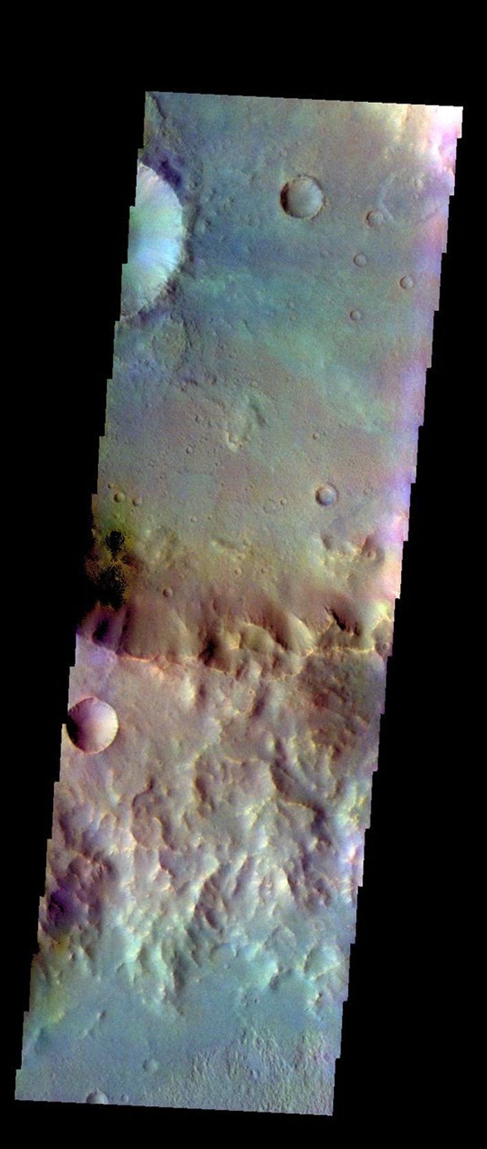 The THEMIS VIS camera contains 5 filters. Data from different filters can be combined in many ways to create a false color image. This image from NASA's 2001 Mars Odyssey spacecraft shows a rim of material between two unnamed craters in Tyrrhena Terra.