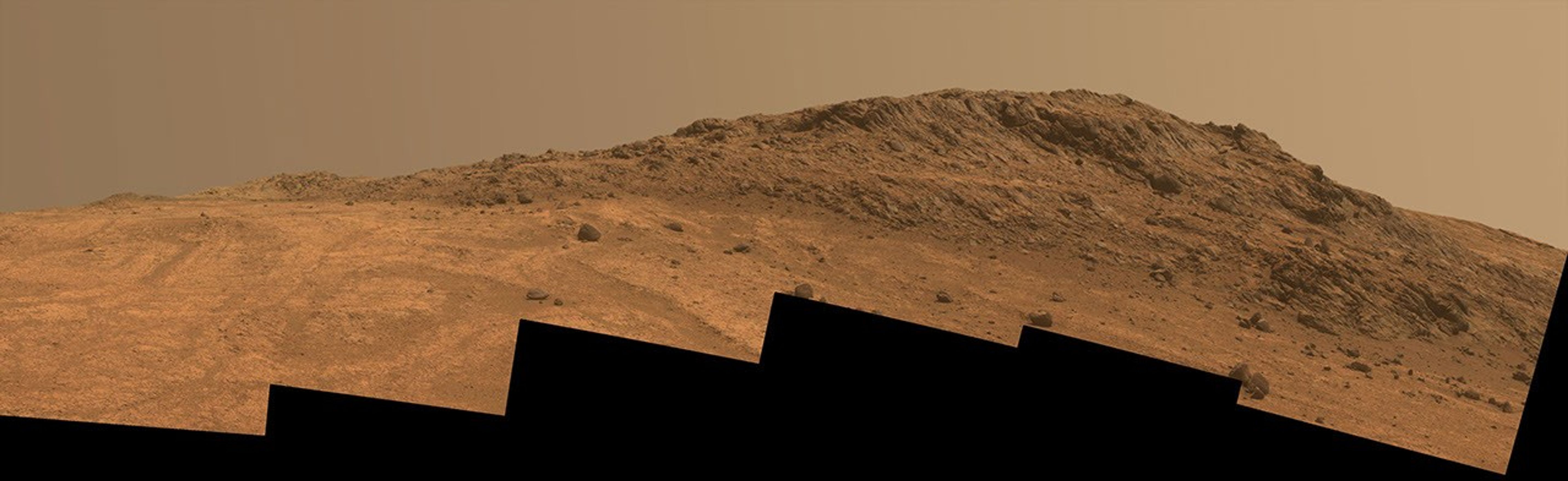 This Martian scene from NASA's Mars rover Opportunity shows contrasting textures and colors of 'Hinners Point,' at the northern edge of 'Marathon Valley,' and swirling reddish zones on the valley floor to the left.