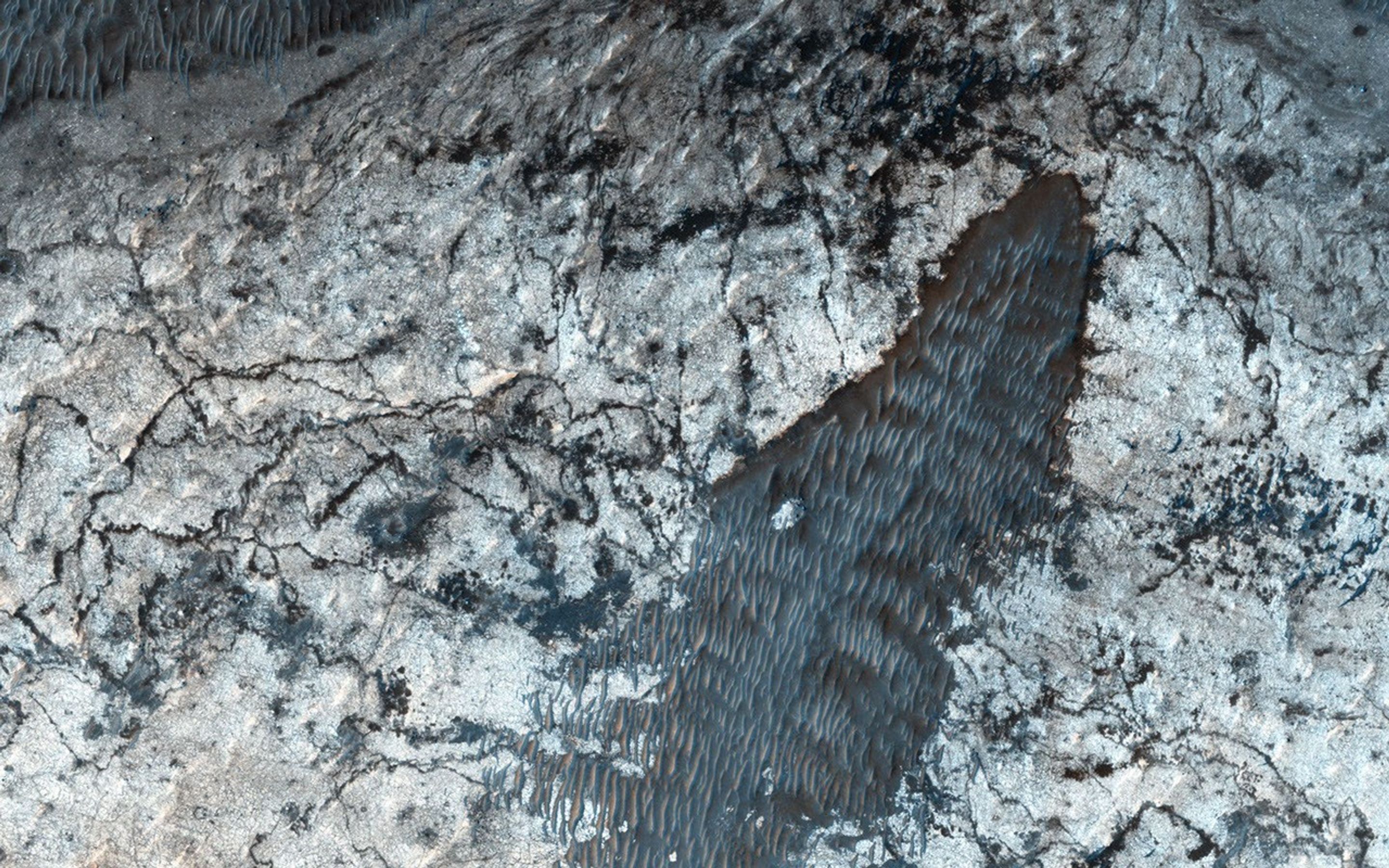 Most larger chasmata contain kilometer-thick light-toned layered deposits composed of sulfates. However, some of the chasmata, like Ius Chasma shown in this image from NASA's Mars Reconnaissance Orbiter, lack these deposits or have much thinner deposits.