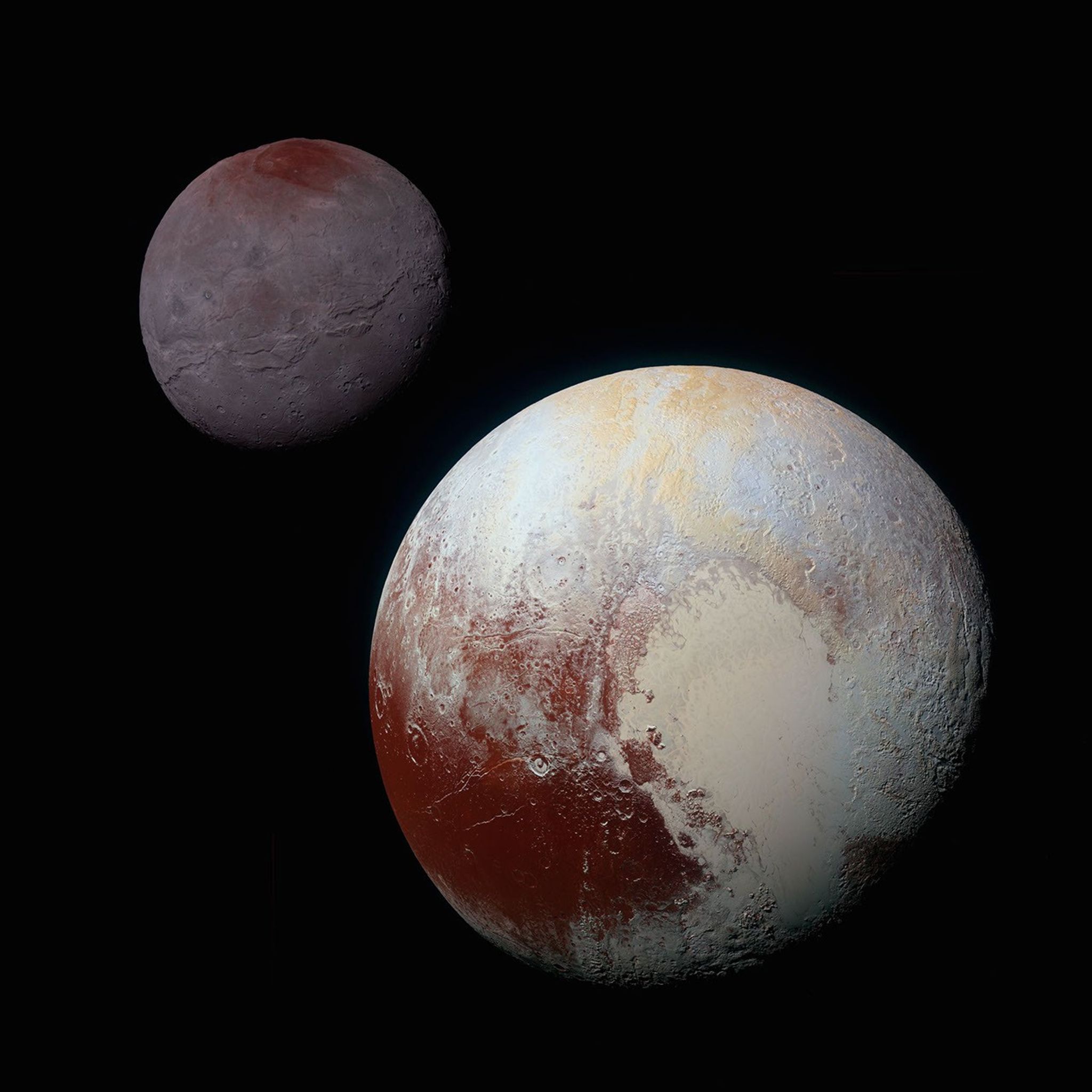 A composite of enhanced color images of Pluto (lower right) and Charon (upper left), taken by NASA's New Horizons spacecraft as it passed through the Pluto system on July 14, 2015. This image highlights the striking differences between Pluto and Charon.