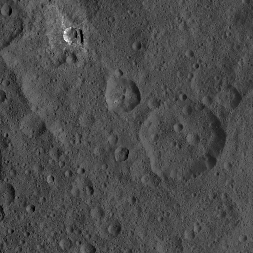 This image of Ceres, taken by NASA's Dawn spacecraft, shows three prominent craters located to the northeast of a terrace (the terrace feature being located at left in this image).