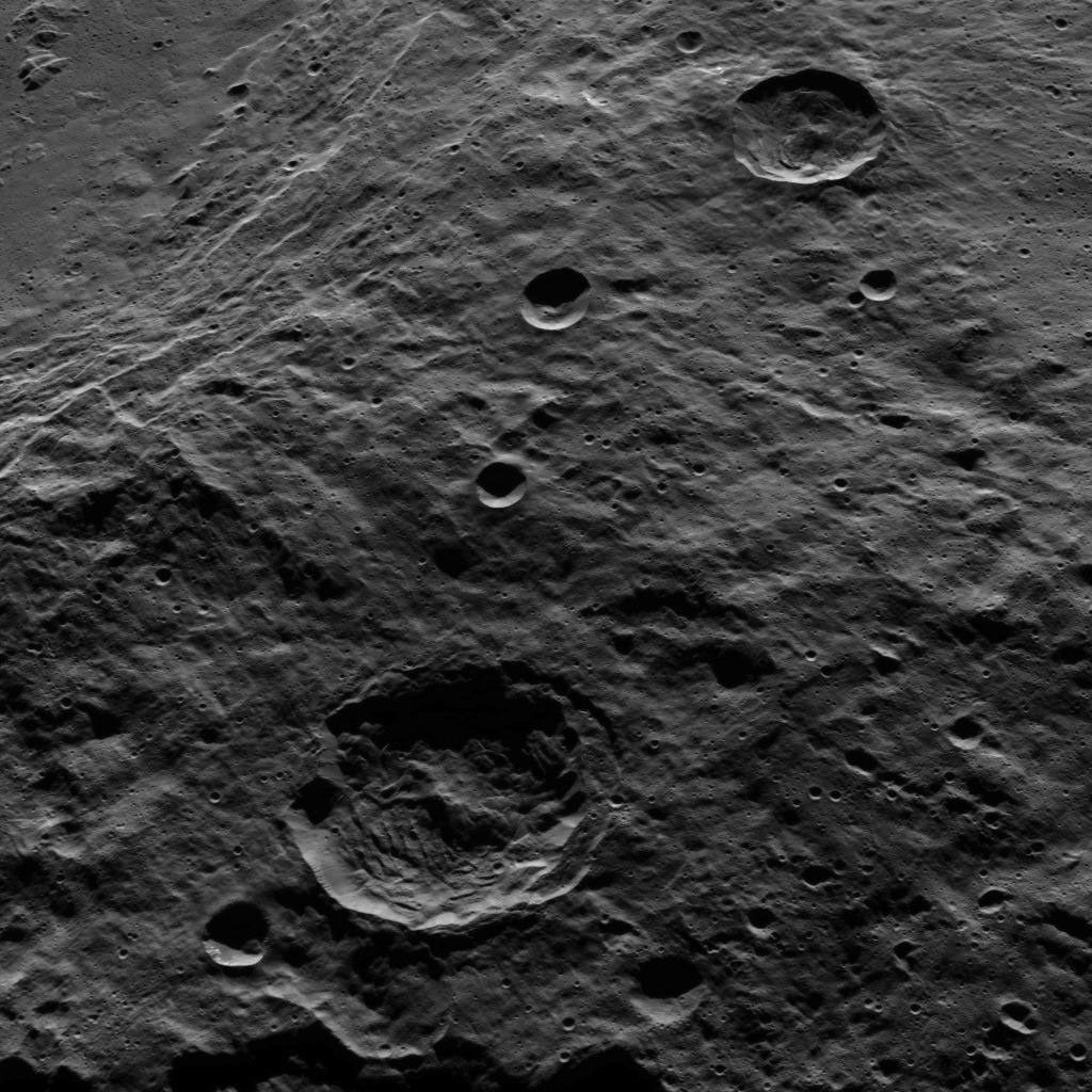 The terraced rim of the large crater named Urvara can be seen at the upper left in this view from Ceres. This image from NASA's Dawn spacecraft shows terrain in the southern hemisphere of the dwarf planet.