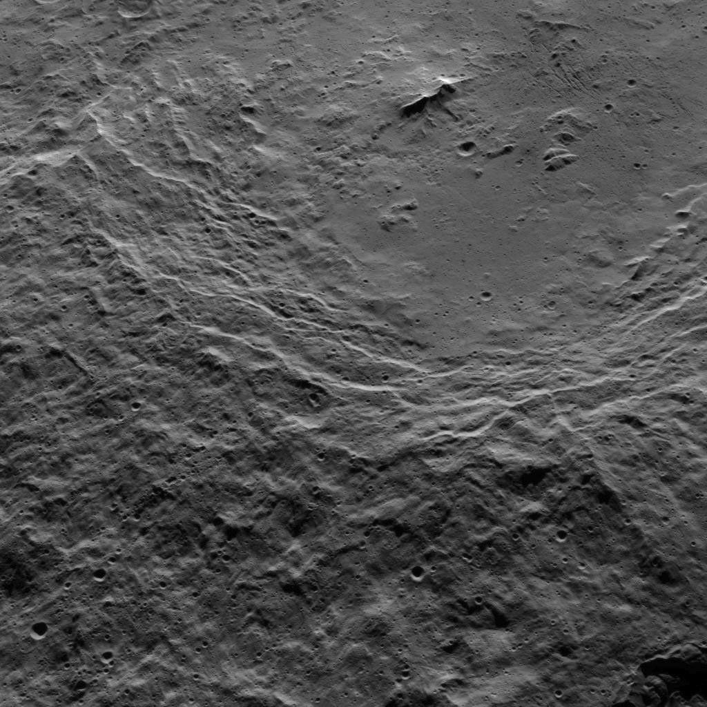 This view shows the southwestern rim of 106-mile-wide (170-kilometer-wide) Urvara crater on Ceres.In the crater's center is a prominent double peak. NASA's Dawn spacecraft obtained the image on Oct. 15, 2015.