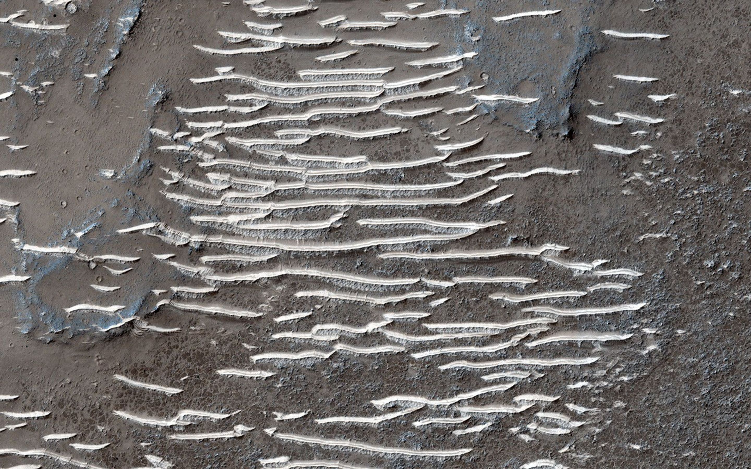 This whole area, located in Solis Planum, is an interesting, tectonic terrain south of Noctis Labrynthus which generally slopes toward the south as seen by NASA's Mars Reconnaissance Orbiter spacecraft.