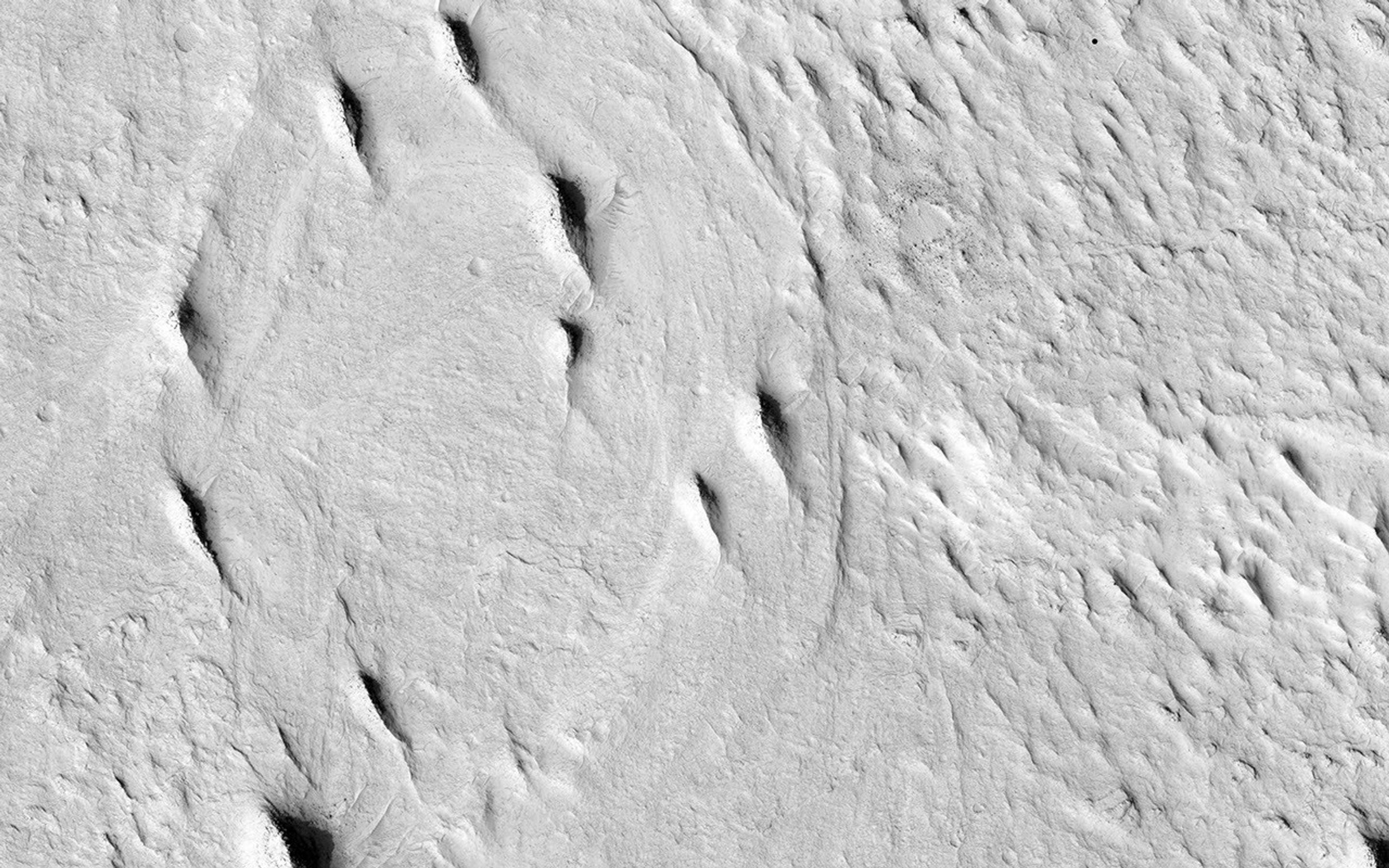This image from NASA's Mars Reconnaissance Orbiter spacecraft contains interesting examples of crosscutting, sinuous and straight ridges. Both ridges may be ancient river deposits.