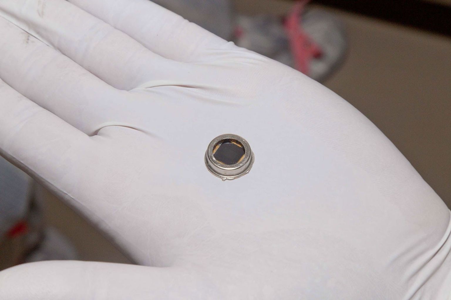 The dime-size microchip in this close-up image carries 826,923 names that will go to Mars on NASA's InSight lander. The image was taken in November 2015 inside a clean room at Lockheed Martin Space Systems, Denver, where the lander was built.