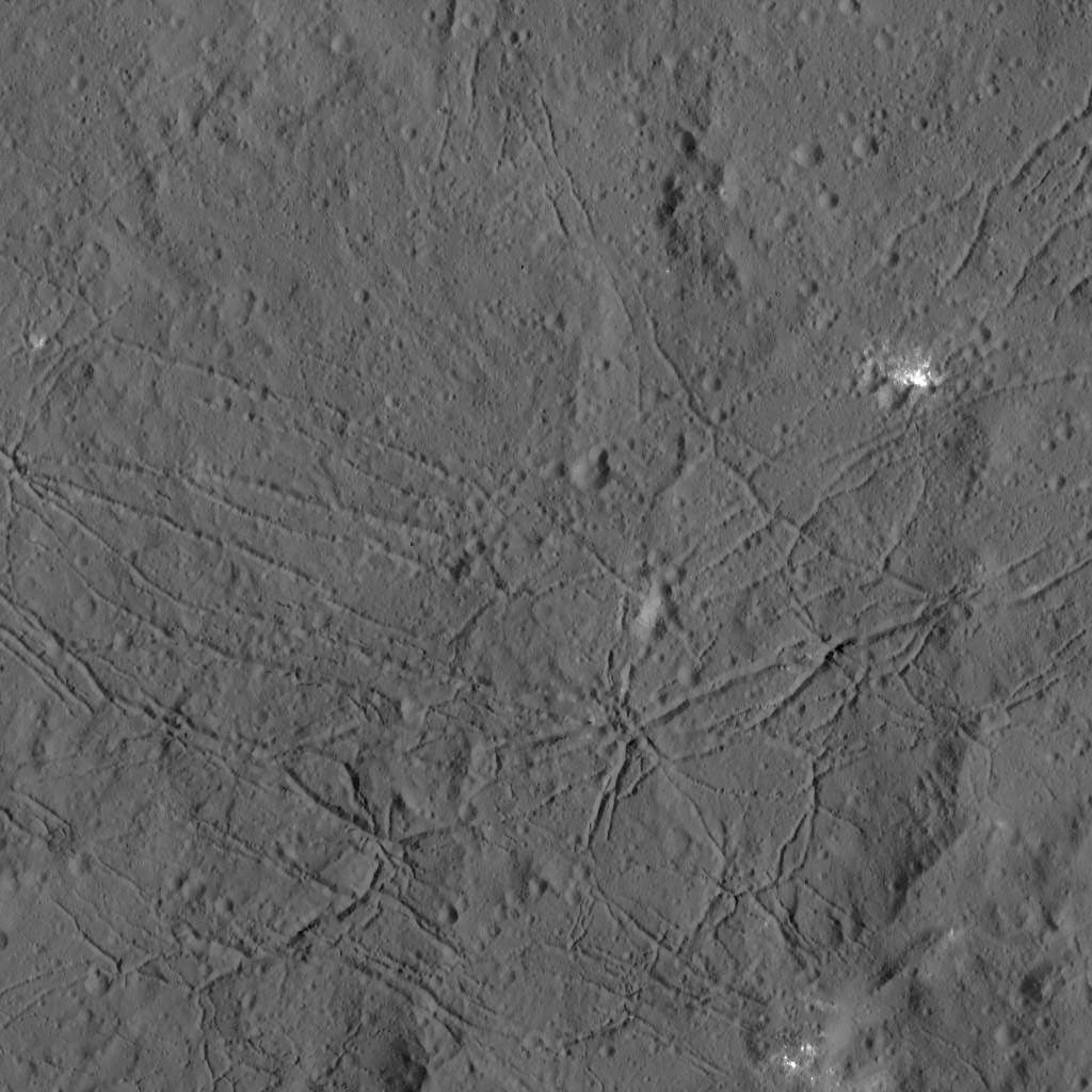 The fractured floor of Dantu Crater on Ceres is seen in this image from NASA's Dawn spacecraft taken on Dec. 21, 2015. Similar fractures are seen in Tycho, one of the youngest large craters on Earth's moon.